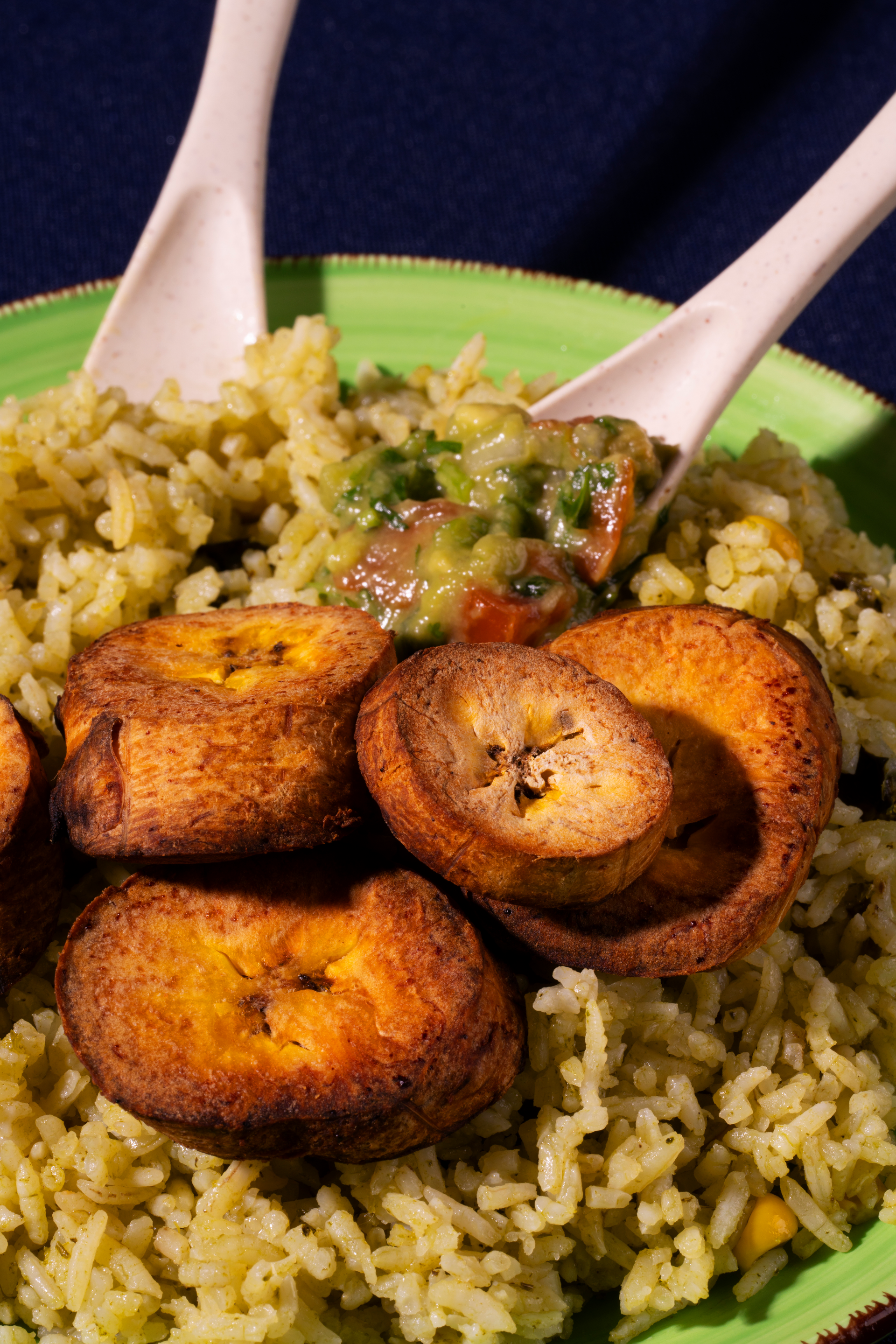 Overhead flat-lay of all ingredients for Spicy Nigerian Jollof Rice with Plantains laid out on a kitchen surface.