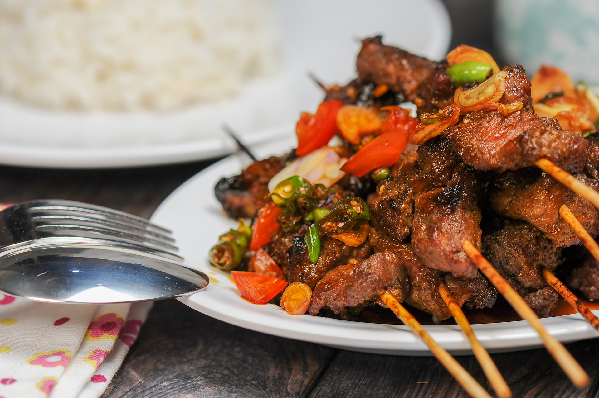 Overhead flat-lay of all ingredients for Spicy Nigerian Suya Skewers laid out on a kitchen surface.