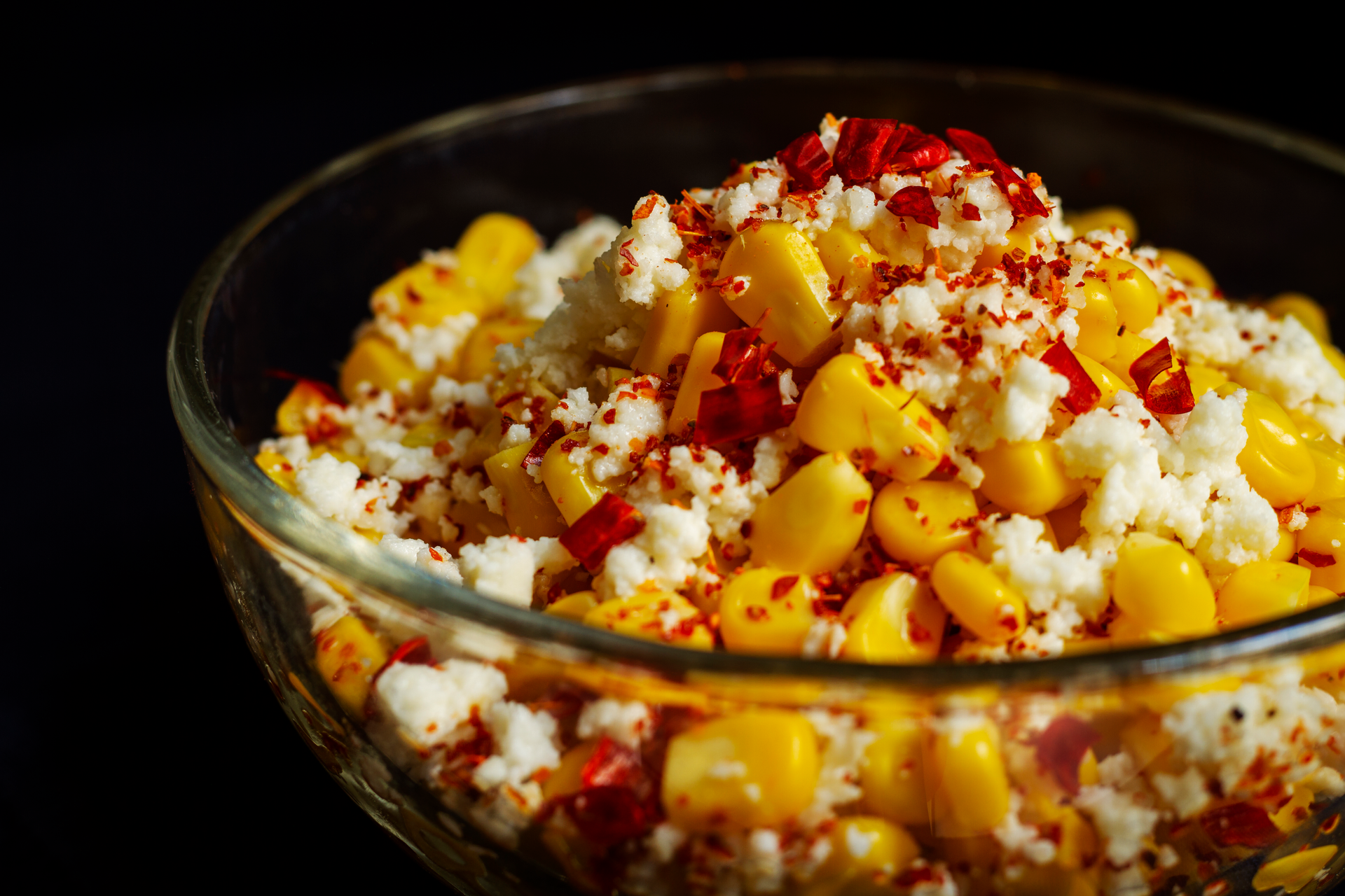 Overhead flat-lay of all ingredients for Spicy Peruvian Ají de Quinoa with Corn and Cheese laid out on a kitchen surface.