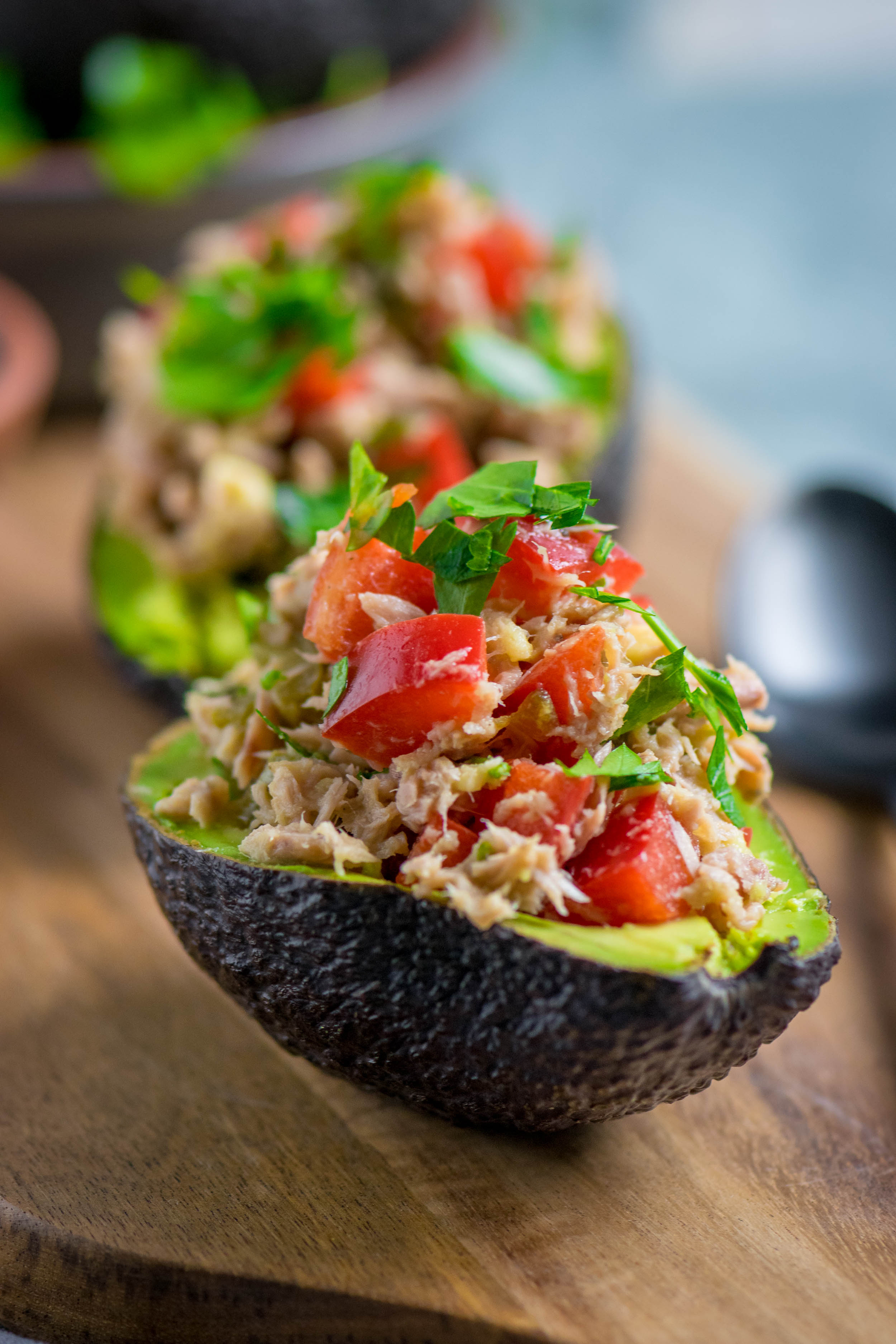 Overhead flat-lay of all ingredients for Spicy Peruvian Avocado Relleno with Quinoa Salad laid out on a kitchen surface.