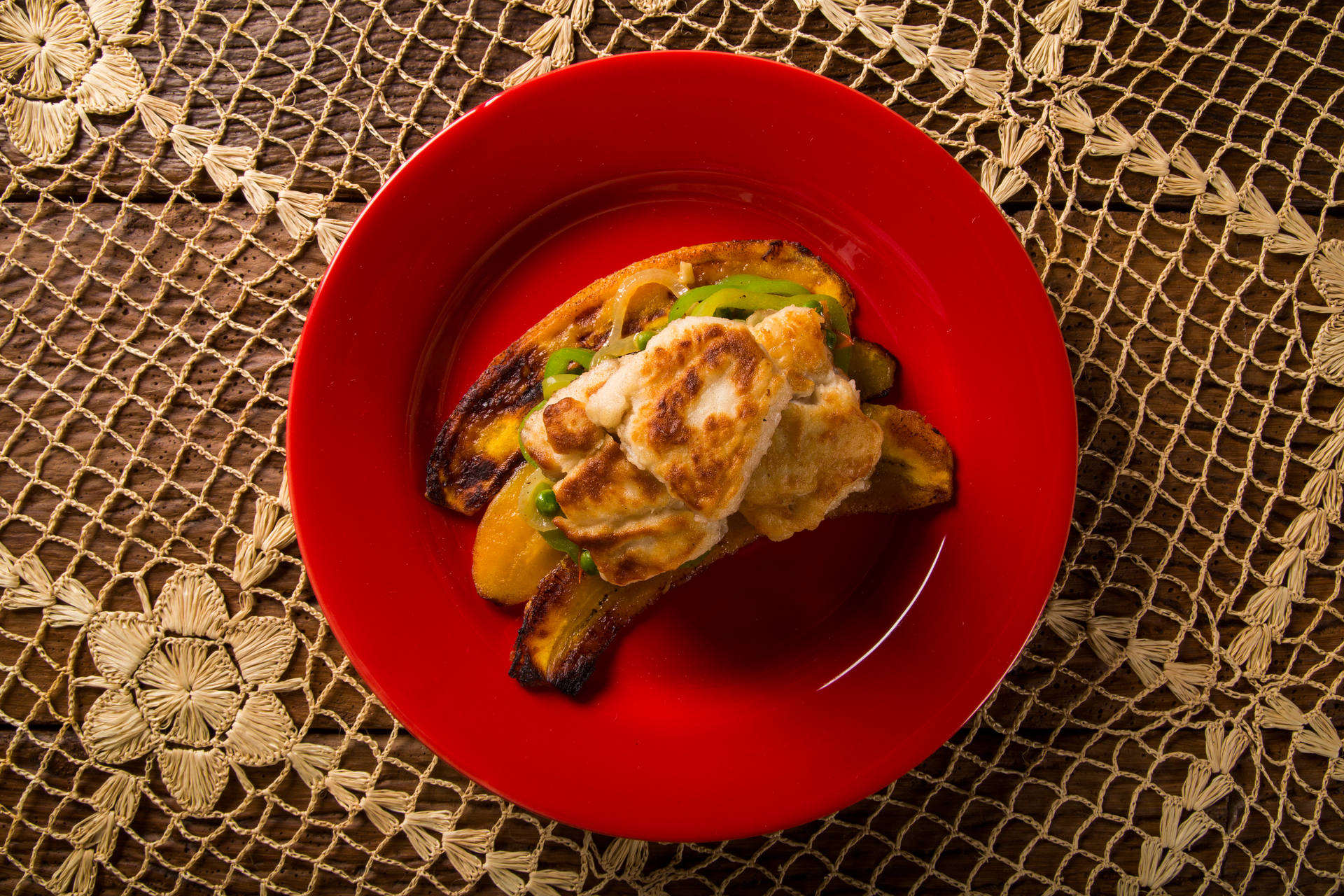 Overhead flat-lay of all ingredients for Spicy Puerto Rican Pastelón with Ripe Plantains laid out on a kitchen surface.