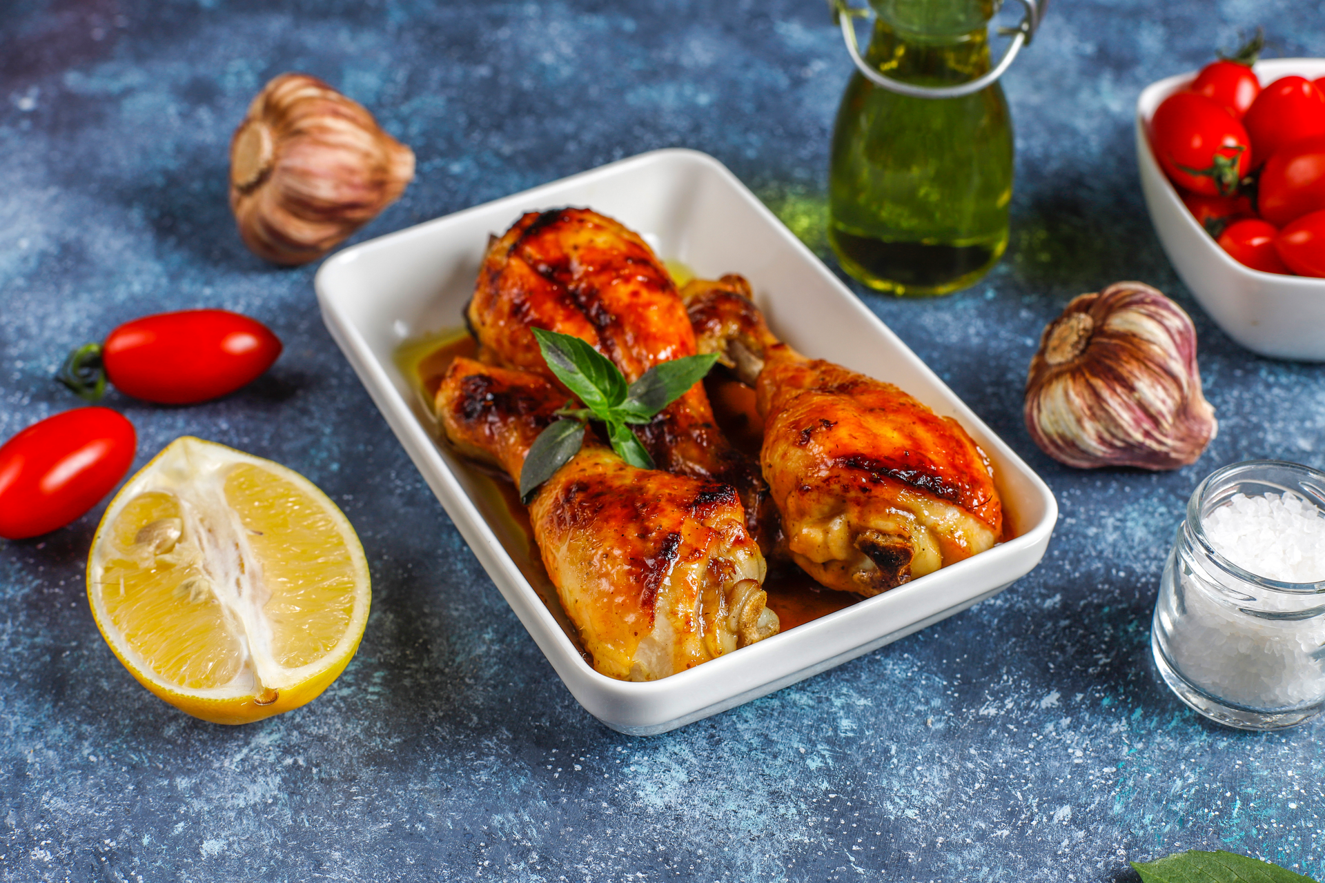 Overhead flat-lay of all ingredients for Spicy Tunisian Charmoula Chicken with Preserved Lemon laid out on a kitchen surface.