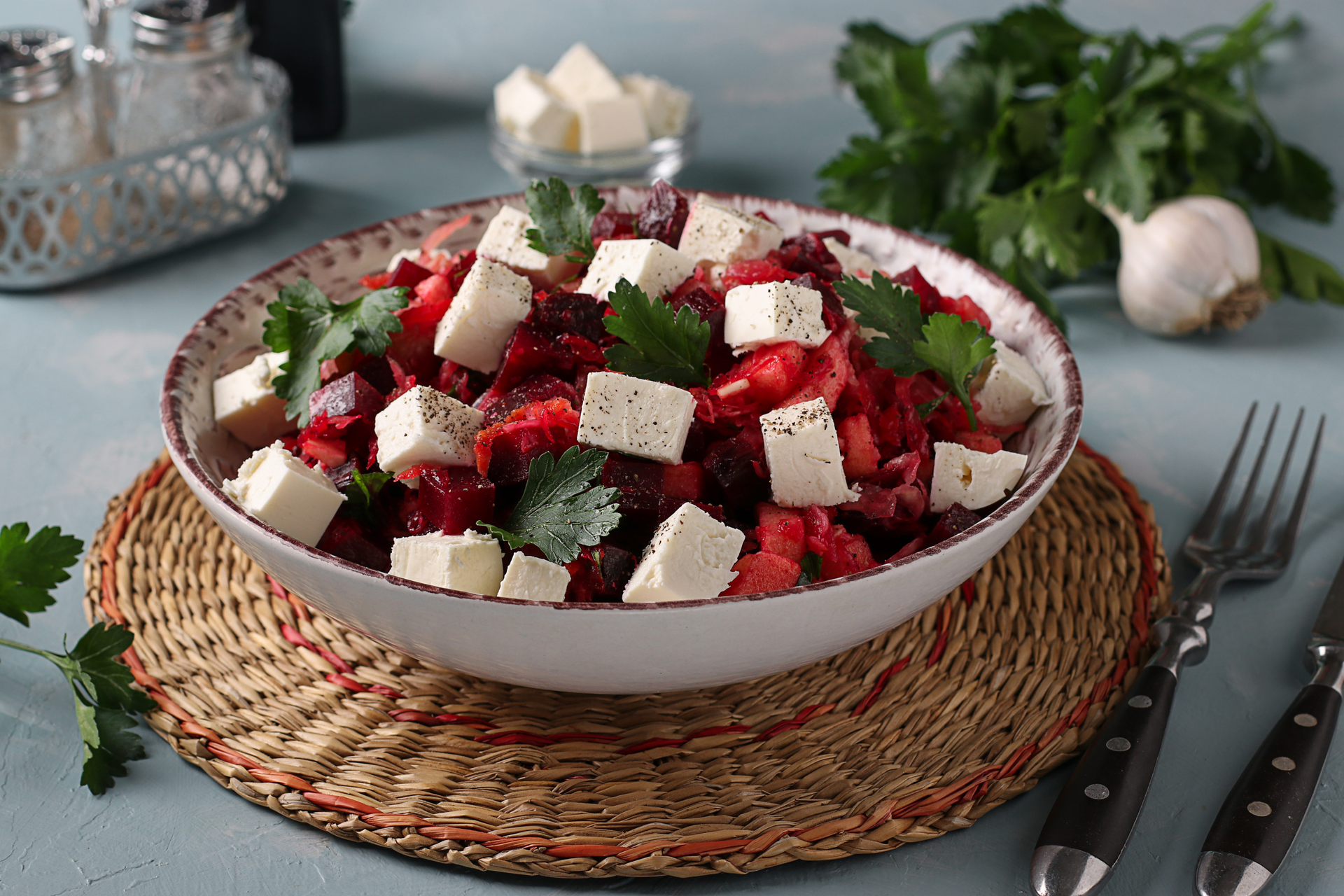 Overhead flat-lay of all ingredients for Spicy Tunisian Harissa Carrot Salad with Crumbled Feta laid out on a kitchen surface.