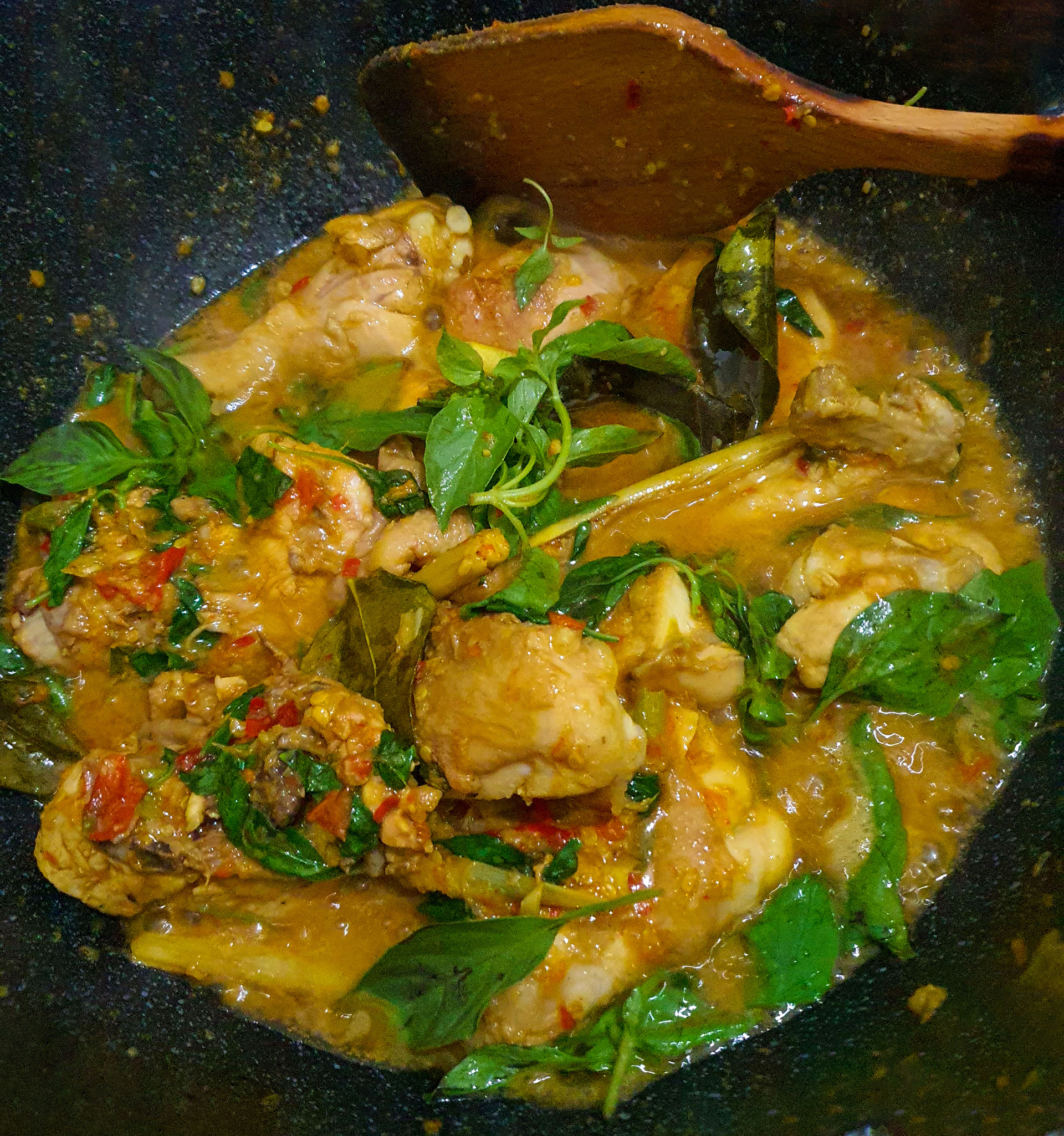 Overhead flat-lay of all ingredients for Sri Lankan Coconut and Curry Leaf Chicken Curry laid out on a kitchen surface.