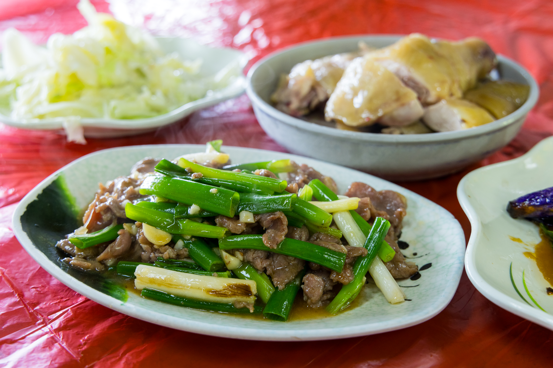 Overhead flat-lay of all ingredients for Succulent Cambodian Lort Cha with Beef and Bok Choy laid out on a kitchen surface.