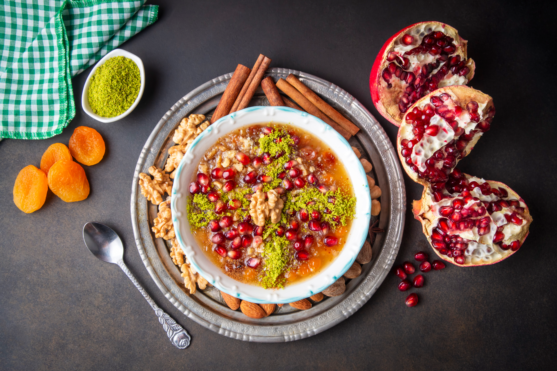 Overhead flat-lay of all ingredients for Sumac-Scented Persian Pomegranate Rice with Pistachios laid out on a kitchen surface.