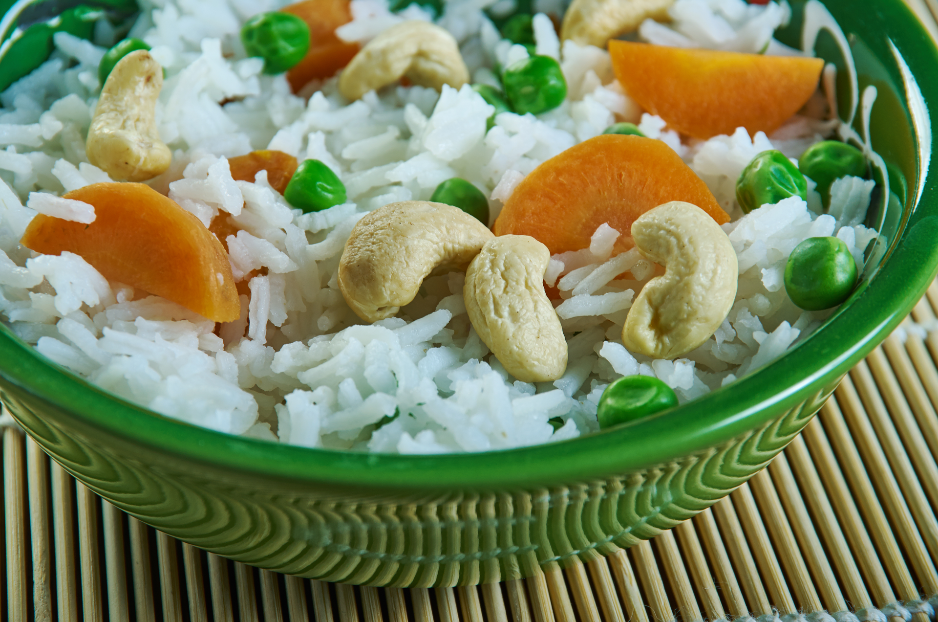 Overhead flat-lay of all ingredients for Sumptuous Haitian Cashew Rice with Coconut and Lime laid out on a kitchen surface.