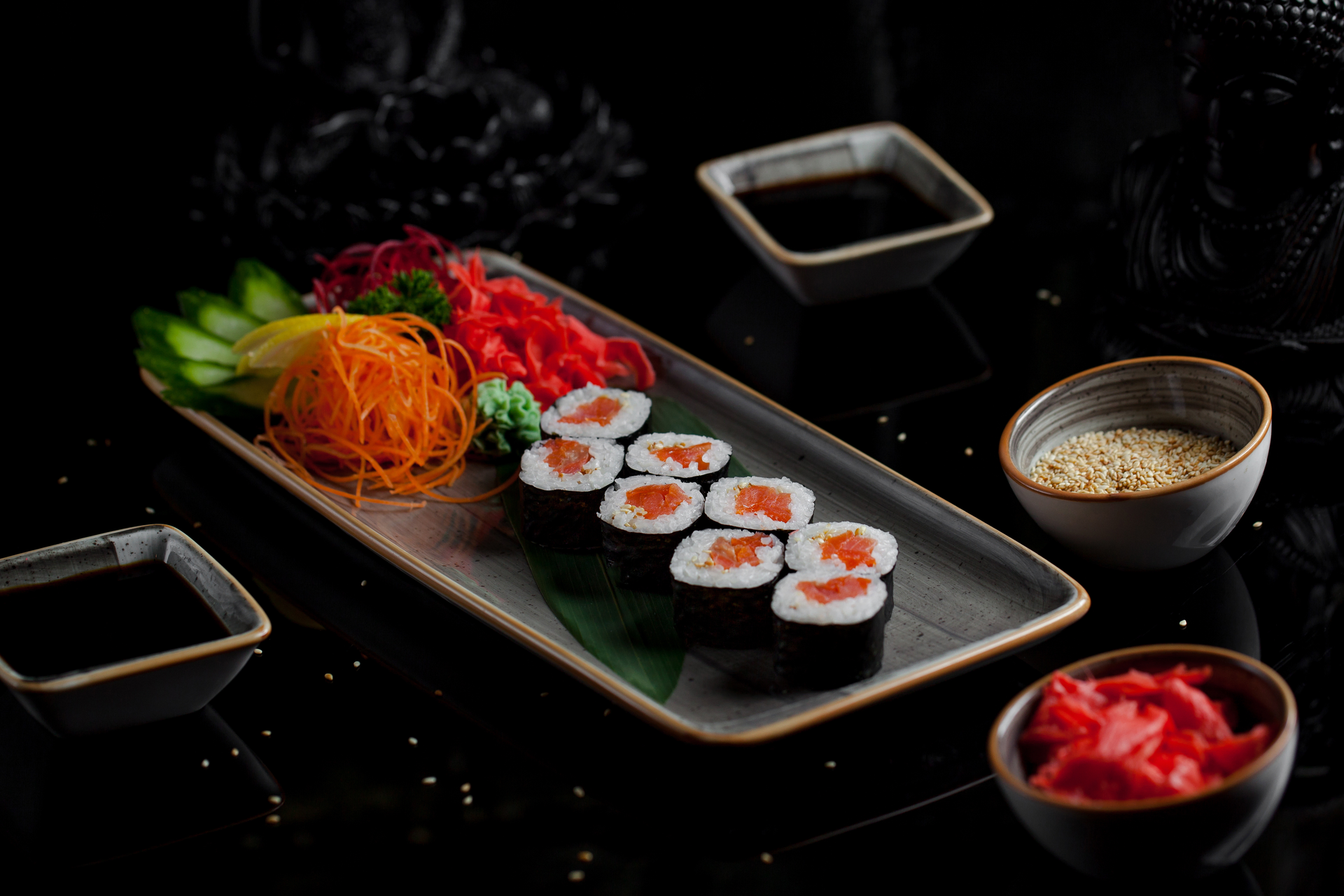 Overhead flat-lay of all ingredients for Sushi laid out on a kitchen surface.