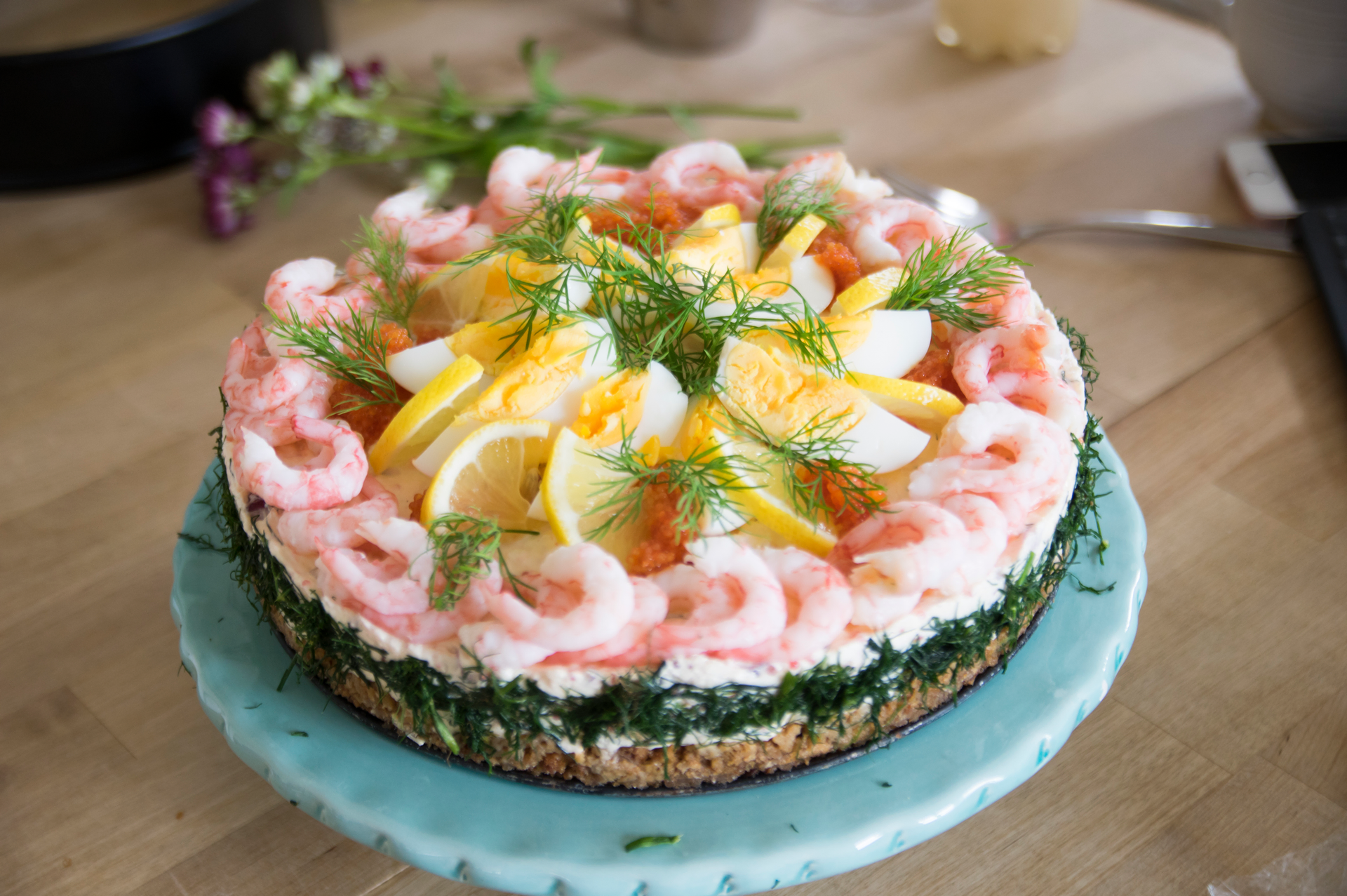 Overhead flat-lay of all ingredients for Swedish Smörgåstårta with Shrimp and Dill laid out on a kitchen surface.