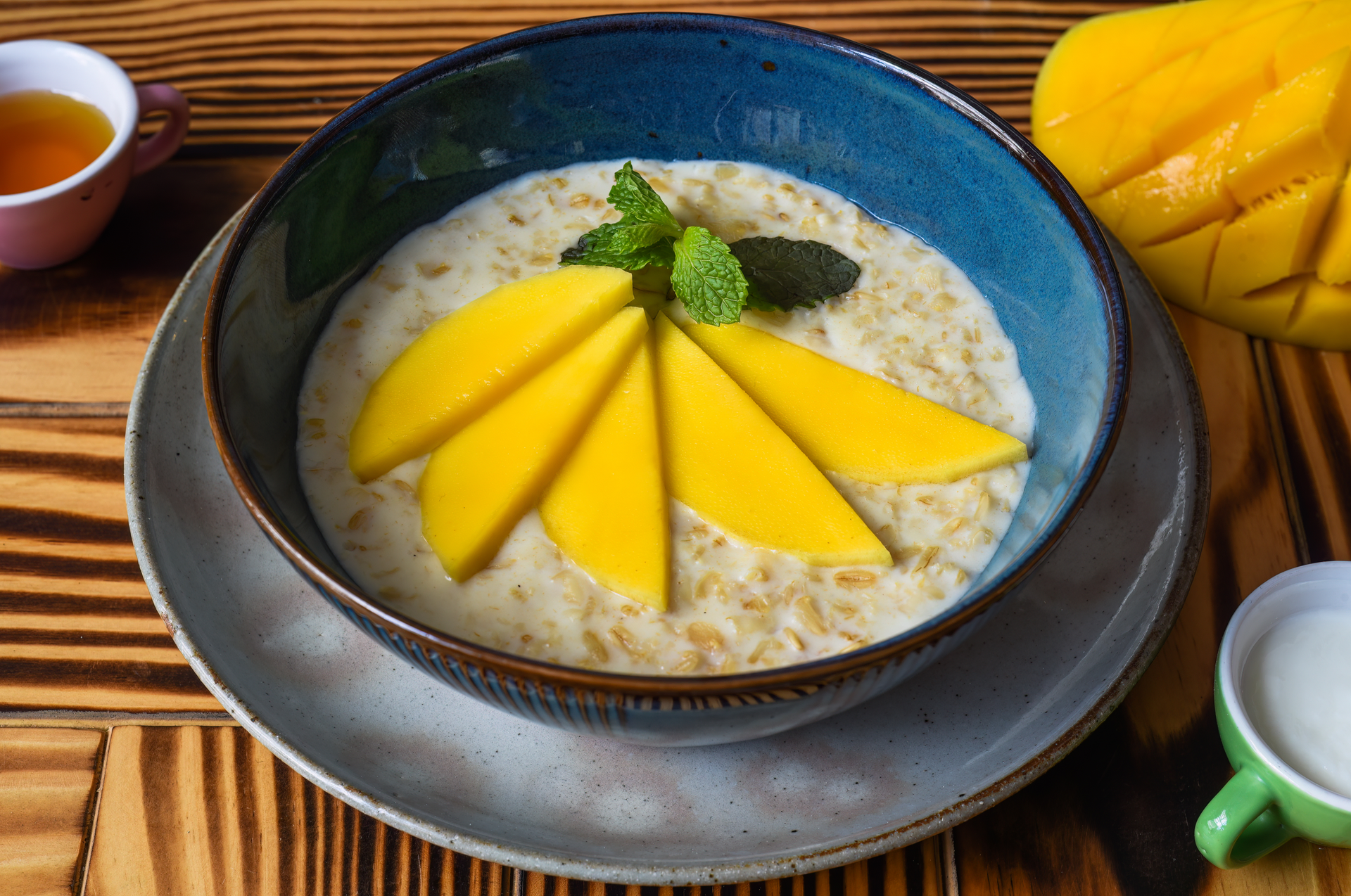 Overhead flat-lay of all ingredients for Sweet and Tangy Vietnamese Mango-Coconut Rice Pudding laid out on a kitchen surface.