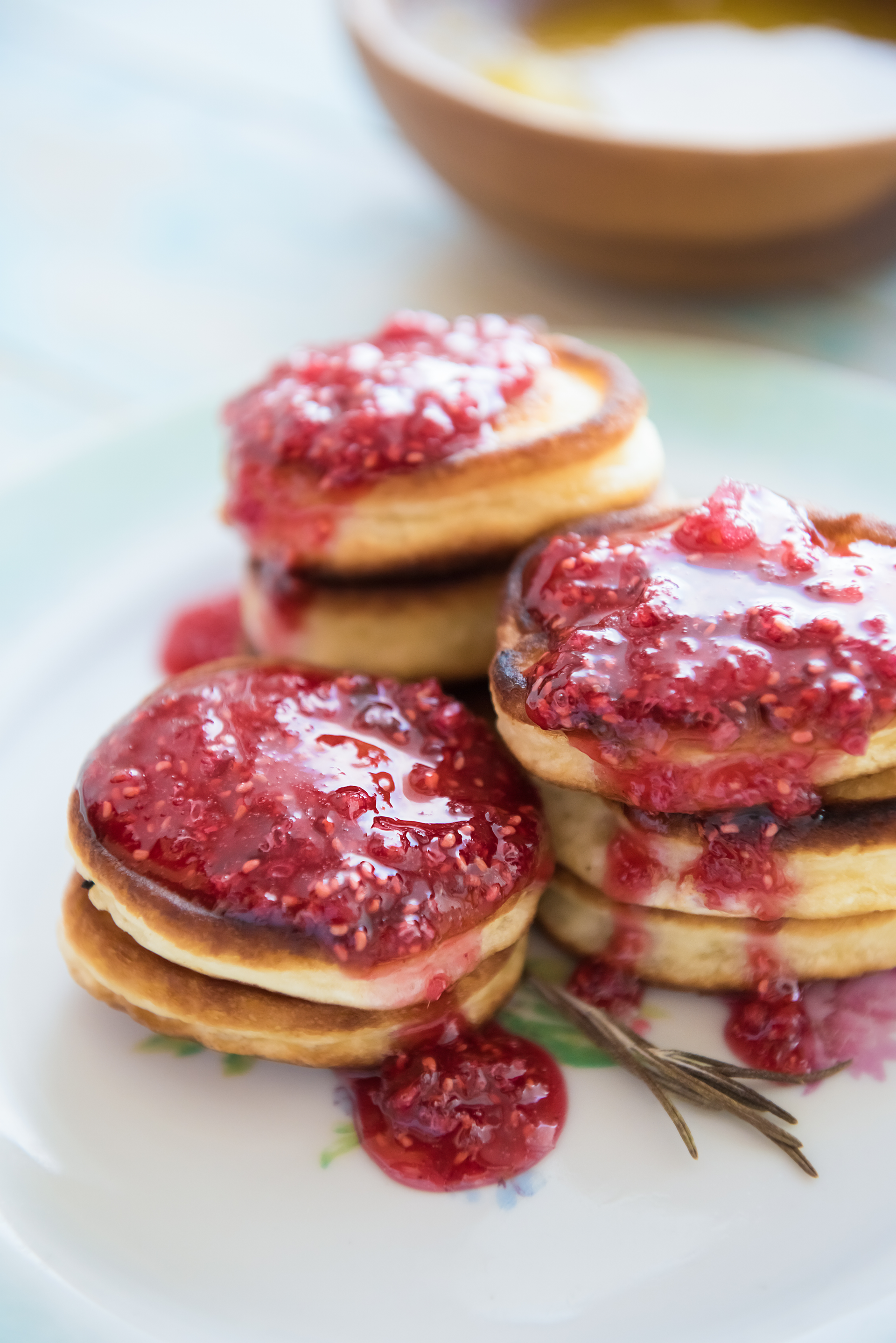 Overhead flat-lay of all ingredients for Sweet Danish Æbleskiver with Cardamom and Raspberry Jam laid out on a kitchen surface.