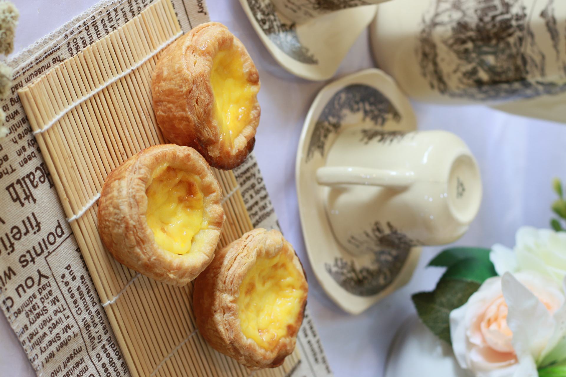 Overhead flat-lay of all ingredients for Sweet Hong Kong Egg Tarts with Buttery Crust laid out on a kitchen surface.