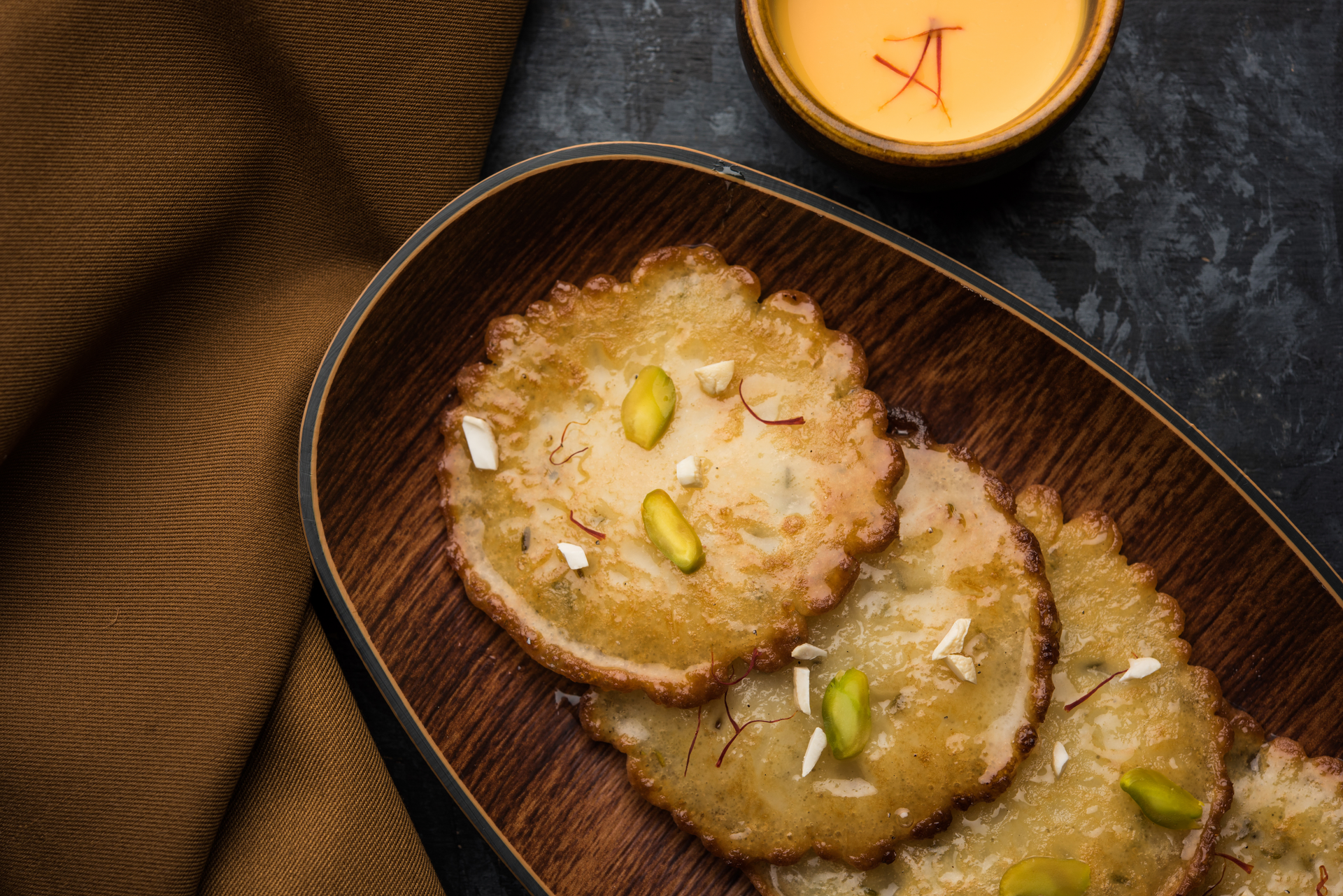 Overhead flat-lay of all ingredients for Sweet Indian Jalebi with Cardamom Syrup laid out on a kitchen surface.