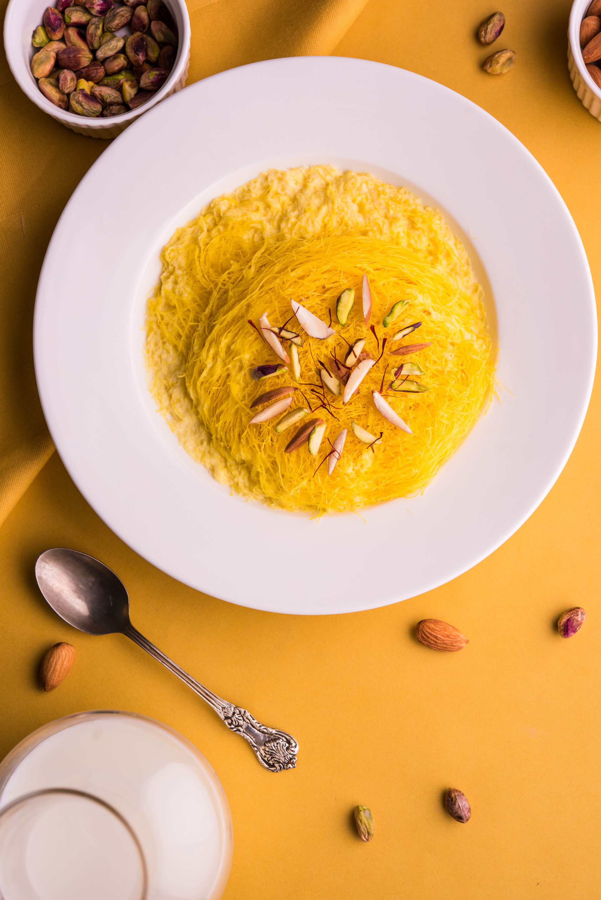 Overhead flat-lay of all ingredients for Sweet Lebanese Sfouf with Turmeric and Pine Nuts laid out on a kitchen surface.