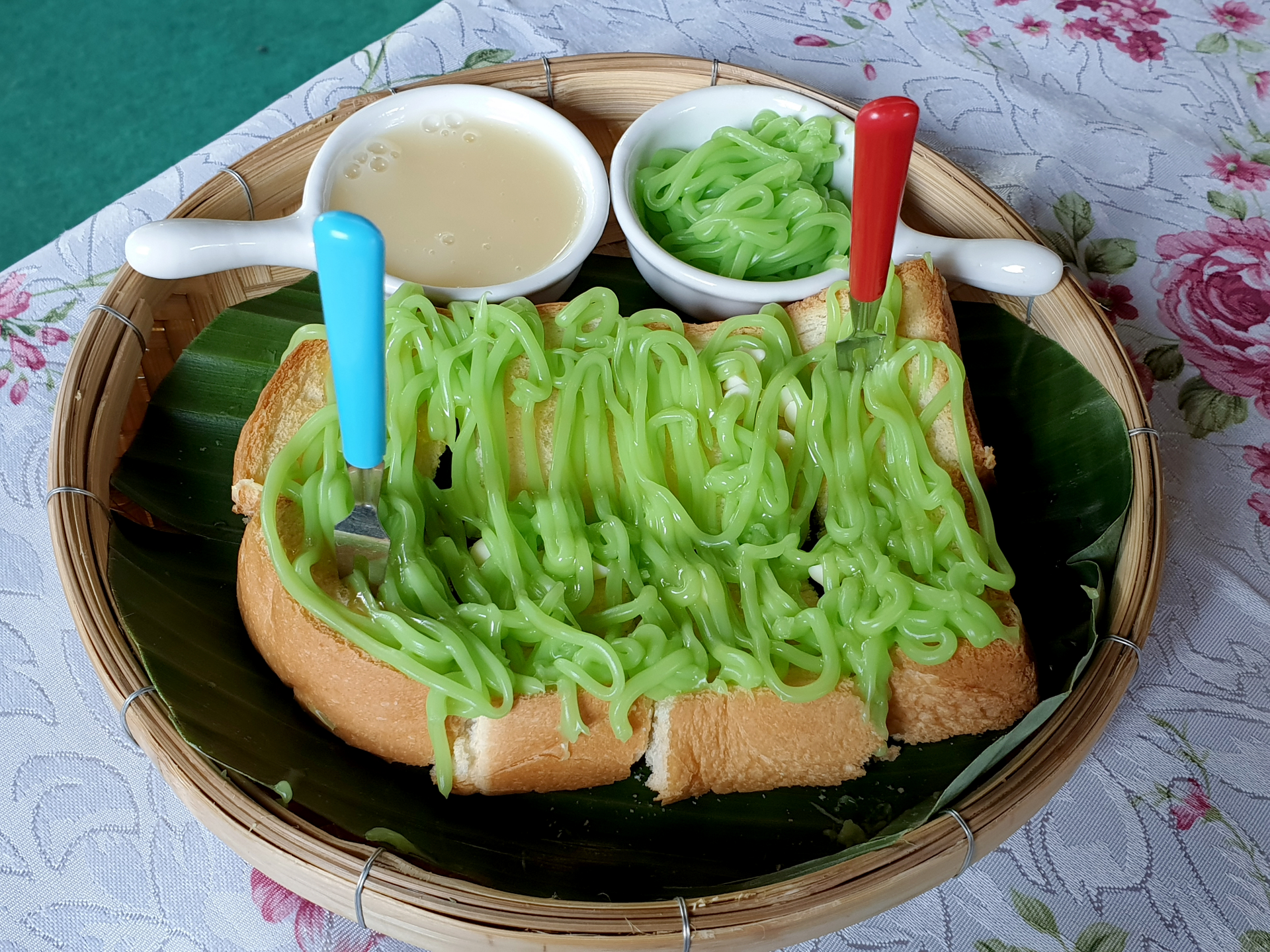 Overhead flat-lay of all ingredients for Sweet Malaysian Kaya Toast with Pandan Coconut Jam laid out on a kitchen surface.