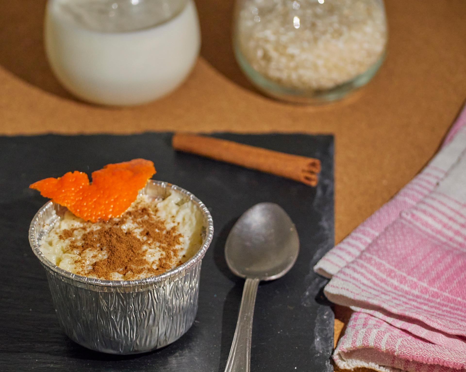 Overhead flat-lay of all ingredients for Sweet Mozambique Coconut Pudding with Cashew Crunch laid out on a kitchen surface.