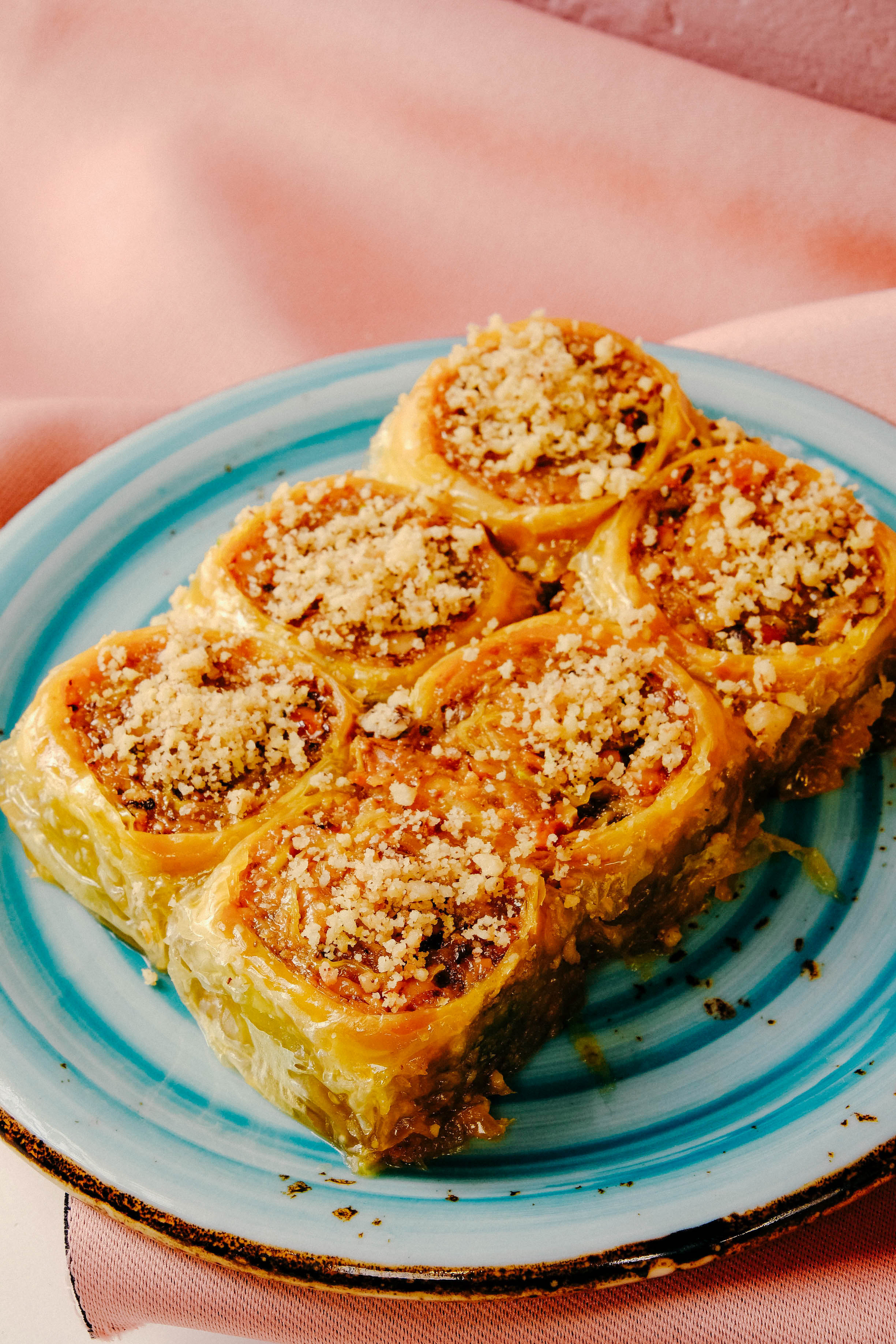 Overhead flat-lay of all ingredients for Sweet Turkish Baklava with Pistachios and Orange Blossom Syrup laid out on a kitchen surface.