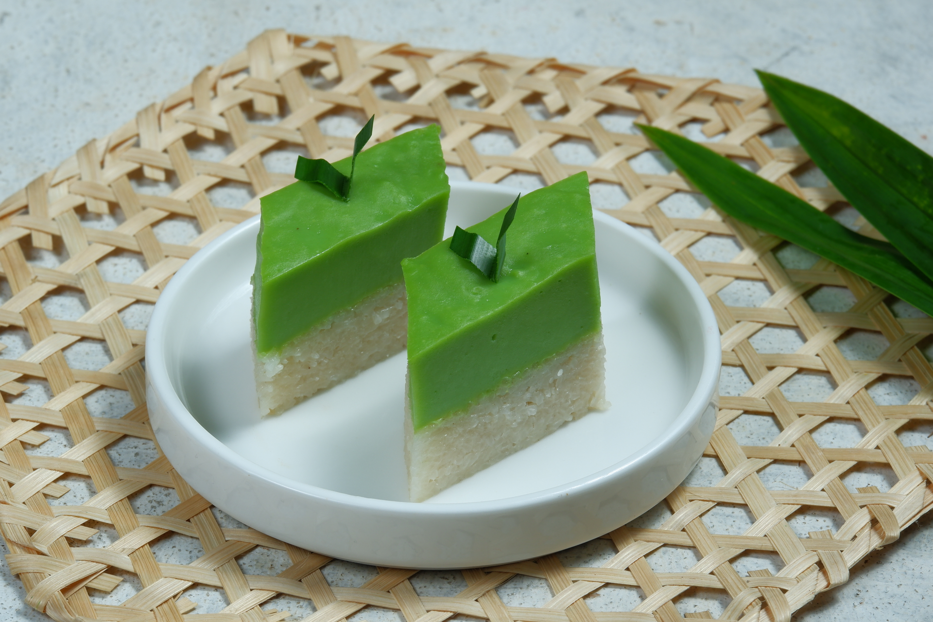Overhead flat-lay of all ingredients for Sweet Vietnamese Pandan Layer Cake with Coconut Cream laid out on a kitchen surface.