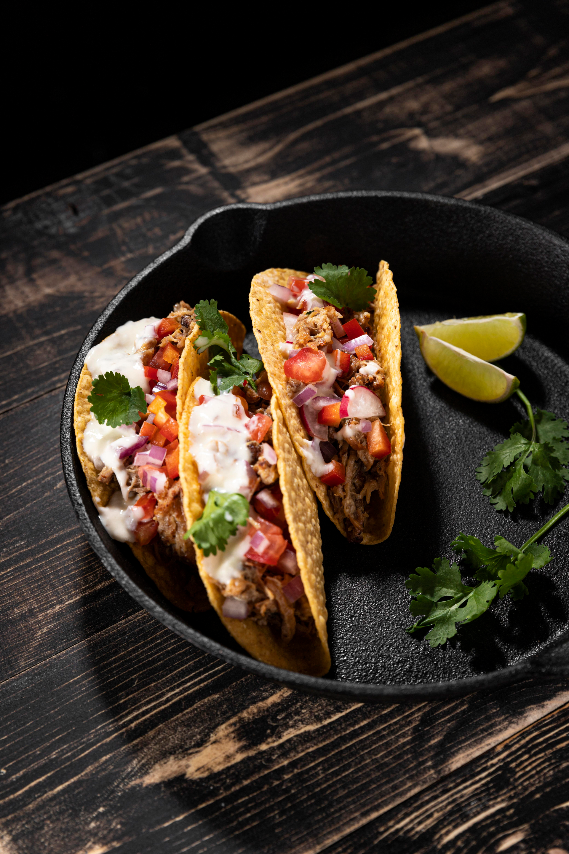 Overhead flat-lay of all ingredients for Tacos al Pastor laid out on a kitchen surface.