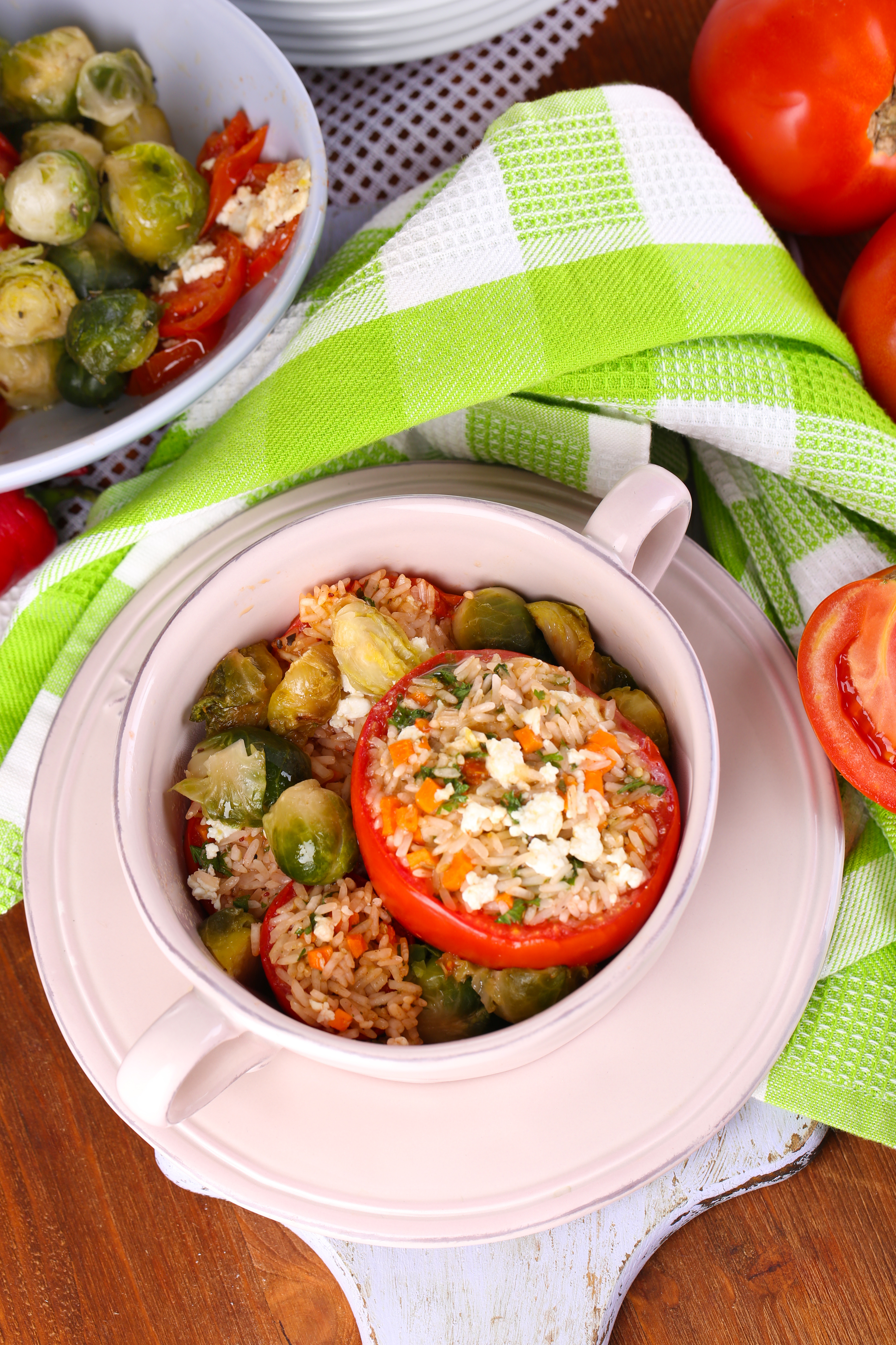 Overhead flat-lay of all ingredients for Tangy Albanian Fërgesë with Peppers and Tomatoes laid out on a kitchen surface.