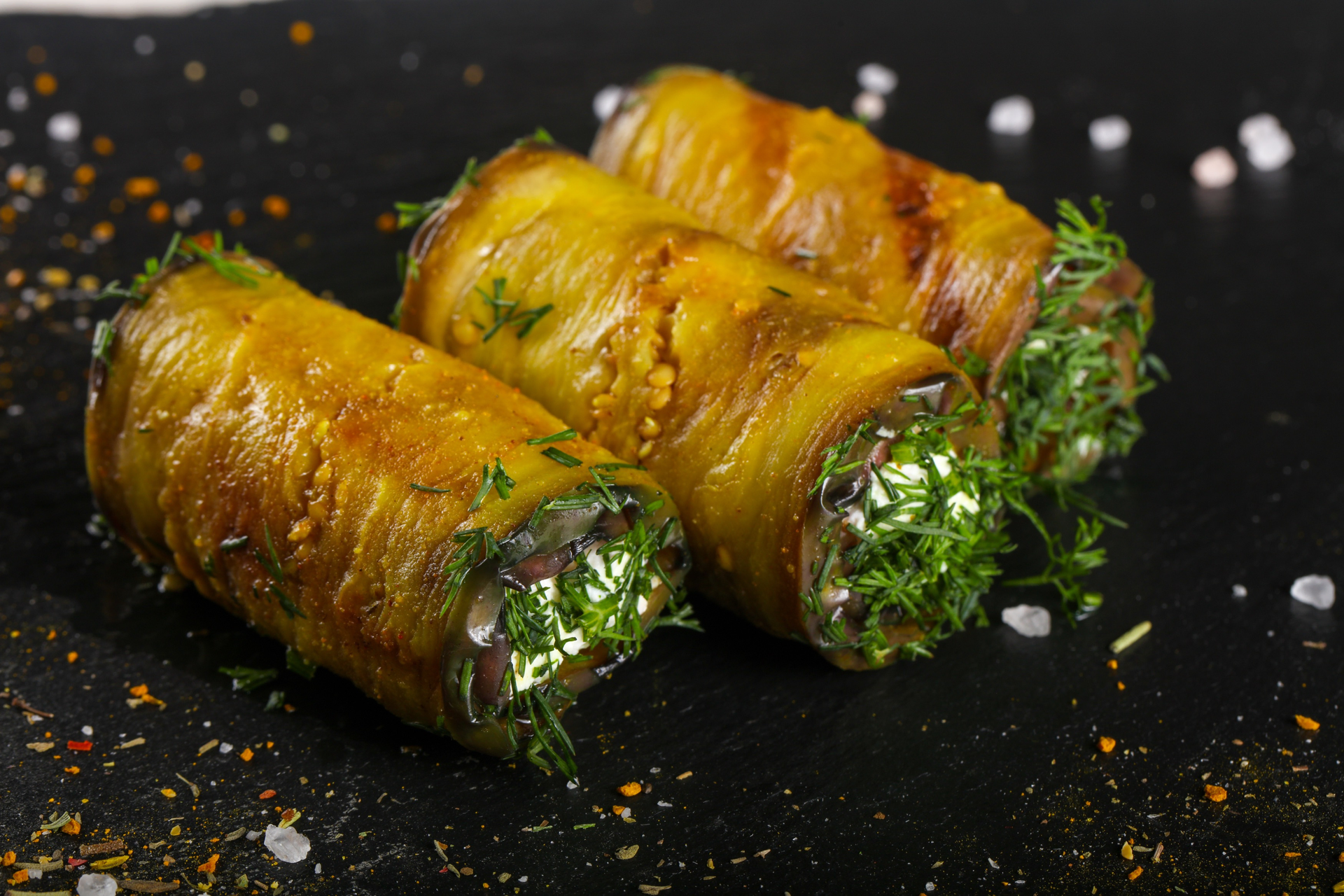 Overhead flat-lay of all ingredients for Tangy Algerian Seffa Roll with Chickpea-Stuffed Grape Leaves laid out on a kitchen surface.