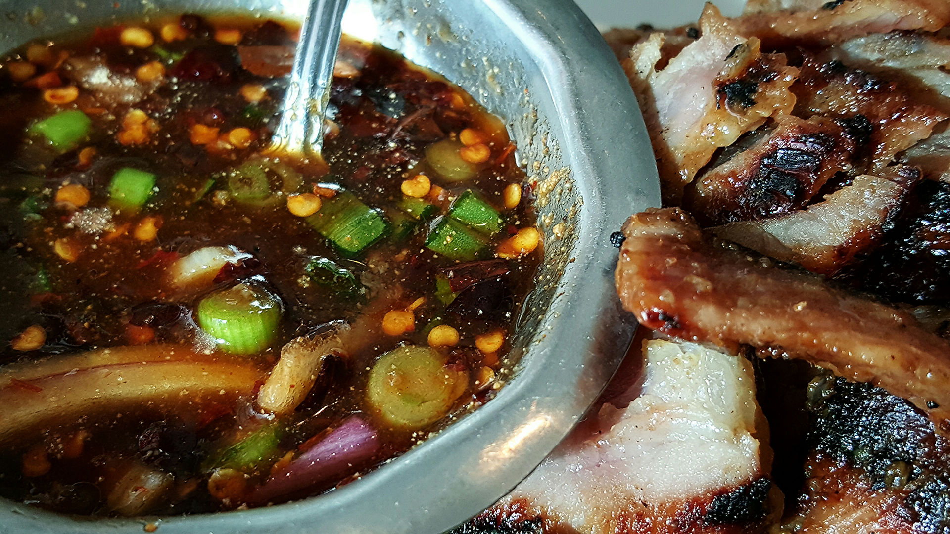 Overhead flat-lay of all ingredients for Tangy Bolivian Majadito with Salted Ribs and Cassava laid out on a kitchen surface.