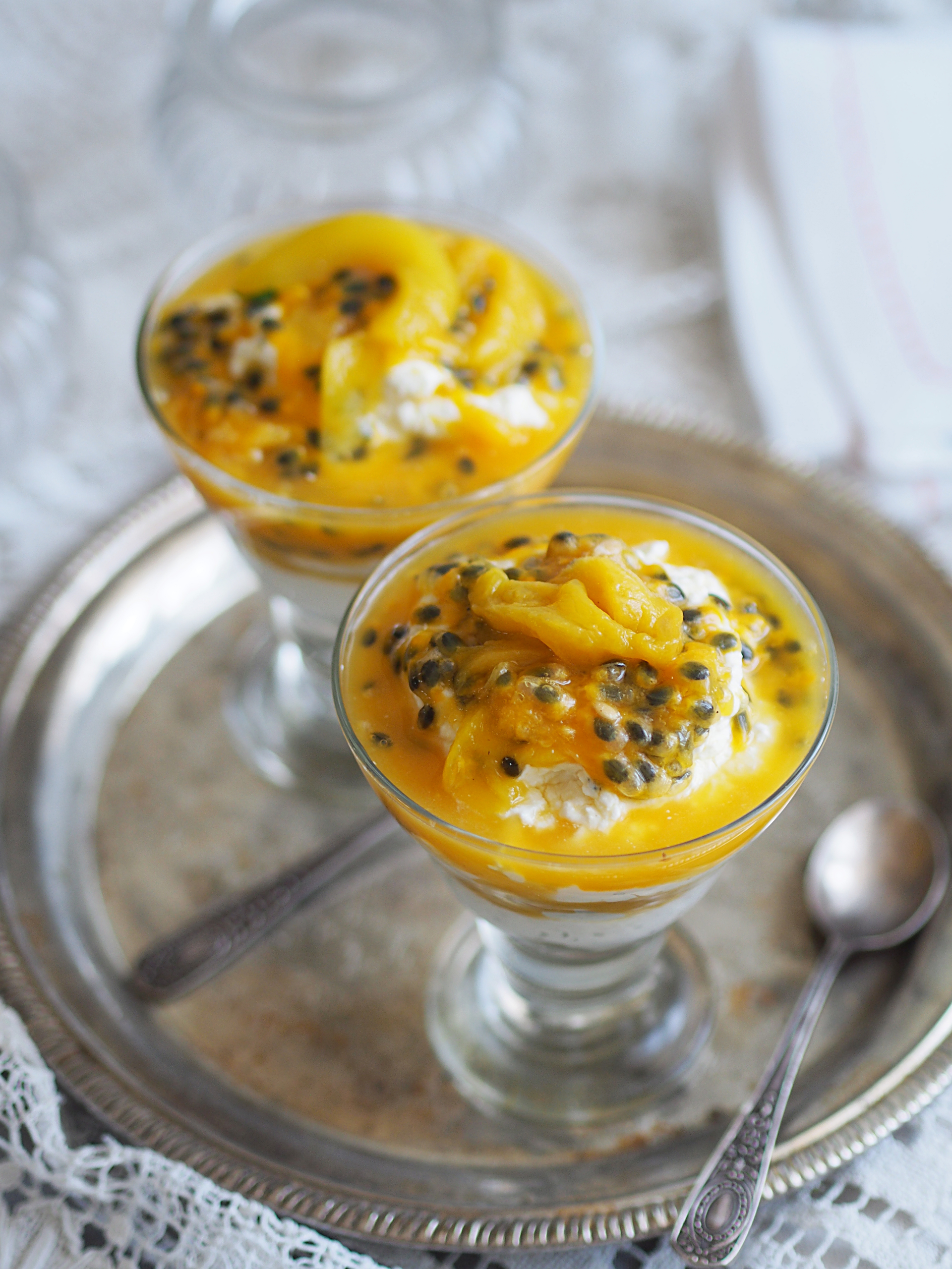 Overhead flat-lay of all ingredients for Tangy Brazilian Maracuja Mousse with Passionfruit Sauce laid out on a kitchen surface.