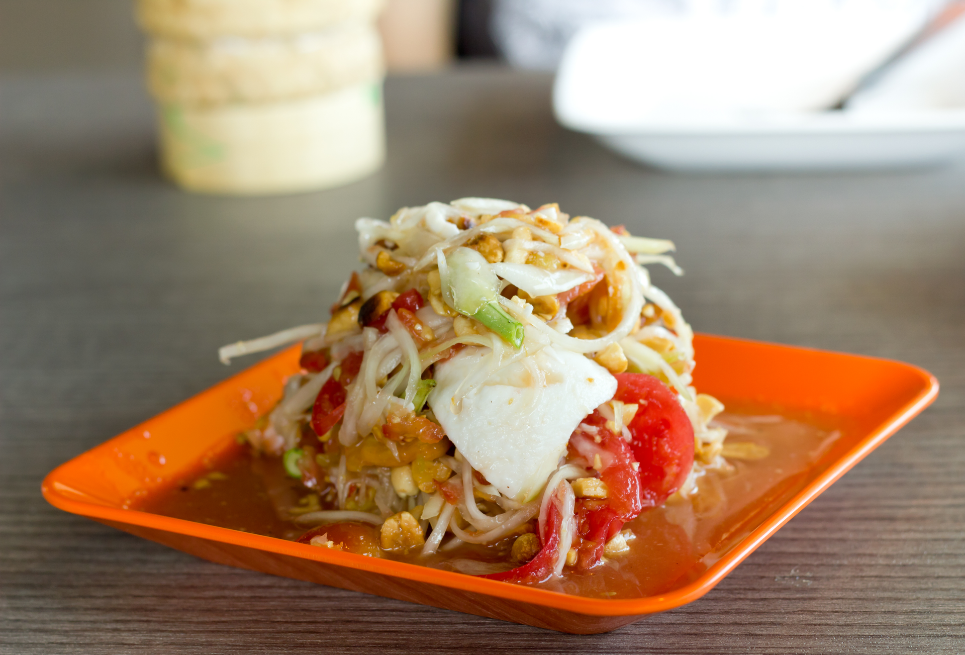 Overhead flat-lay of all ingredients for Tangy Burmese Laphet Thoke laid out on a kitchen surface.