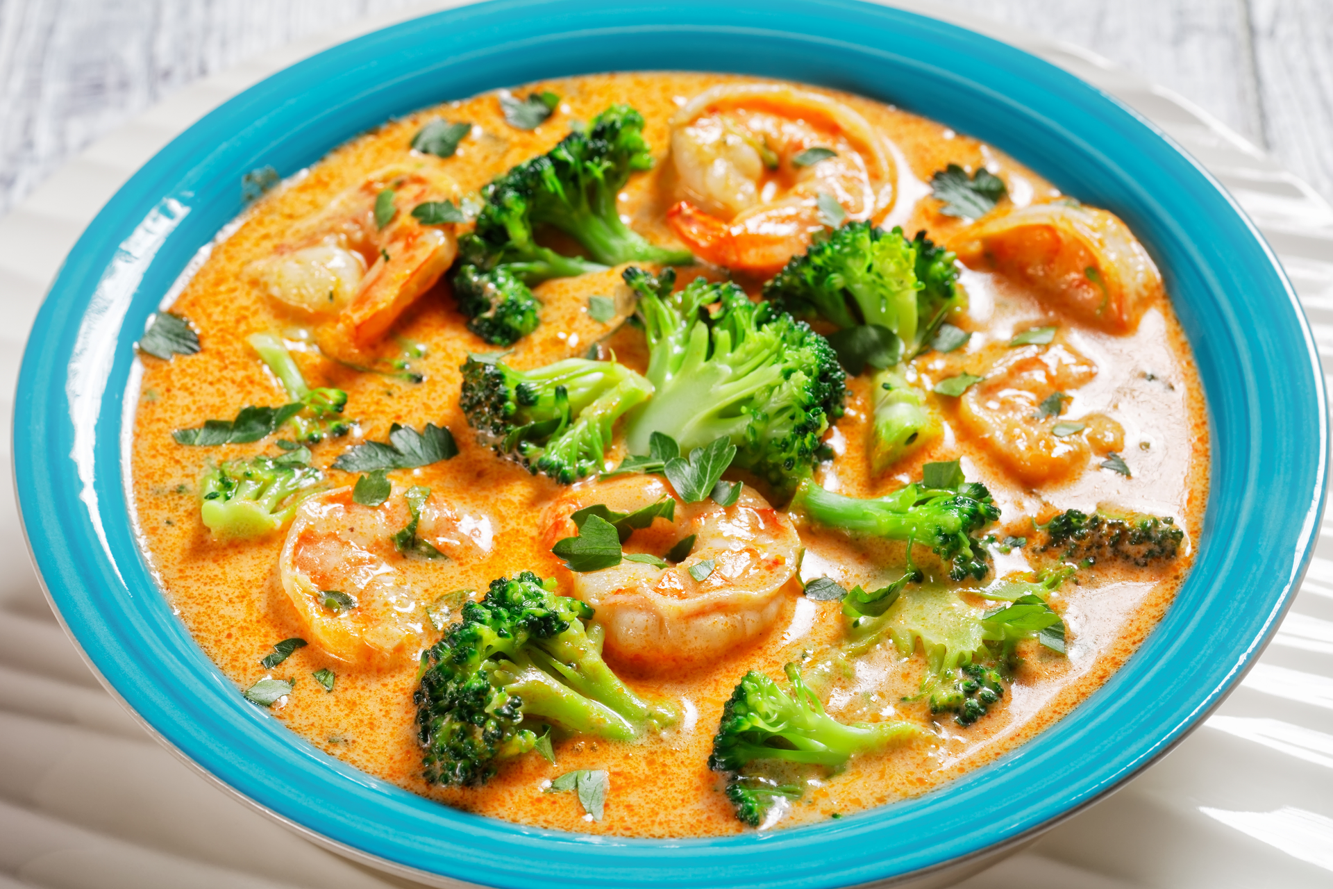 Overhead flat-lay of all ingredients for Tangy Burmese Shrimp Curry with Mustard Greens laid out on a kitchen surface.
