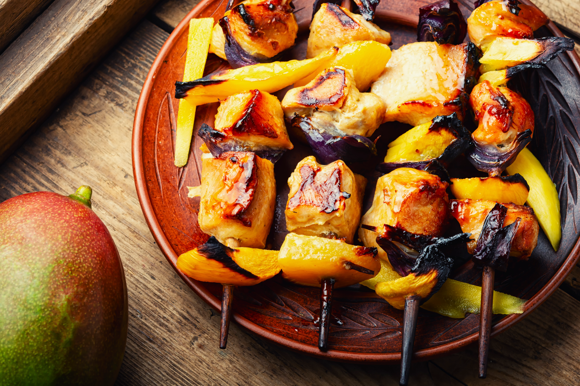 Overhead flat-lay of all ingredients for Tangy Caribbean Mojo Pork with Grilled Peaches laid out on a kitchen surface.