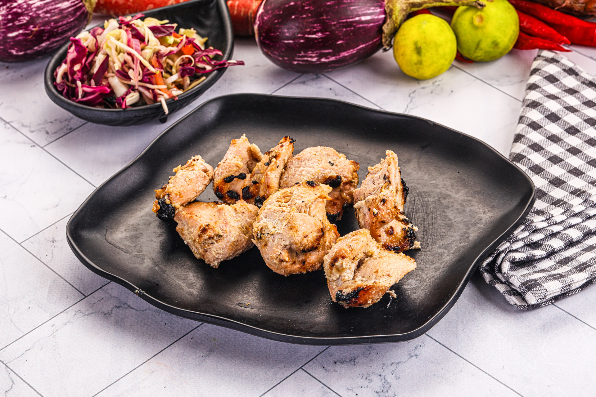 Overhead flat-lay of all ingredients for Tangy Egyptian Tamarind Chicken with Caramelized Onions laid out on a kitchen surface.