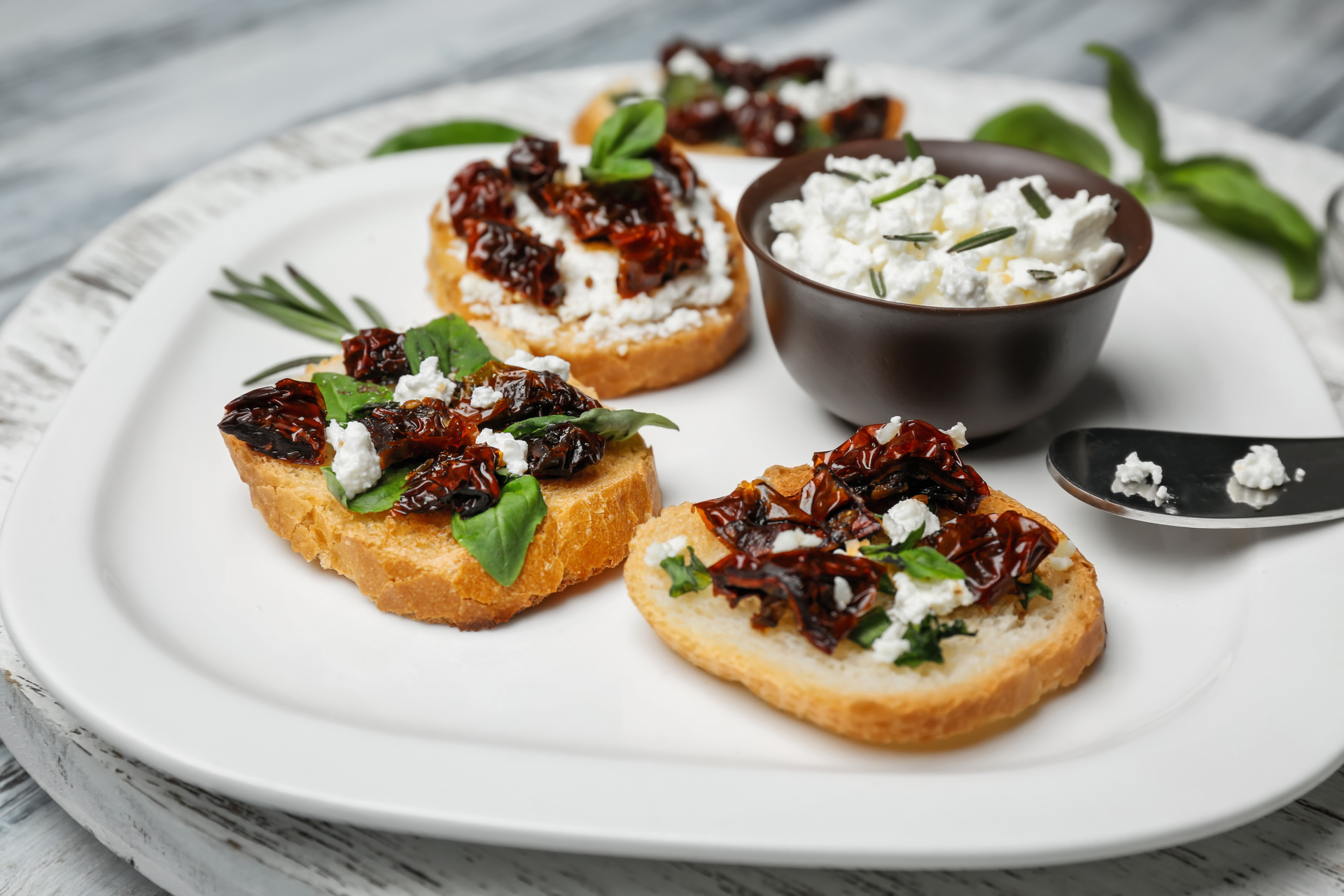 Tangy Greek Kalamata Olive Tapenade Crostini with Feta — Appetizer served and photographed from above