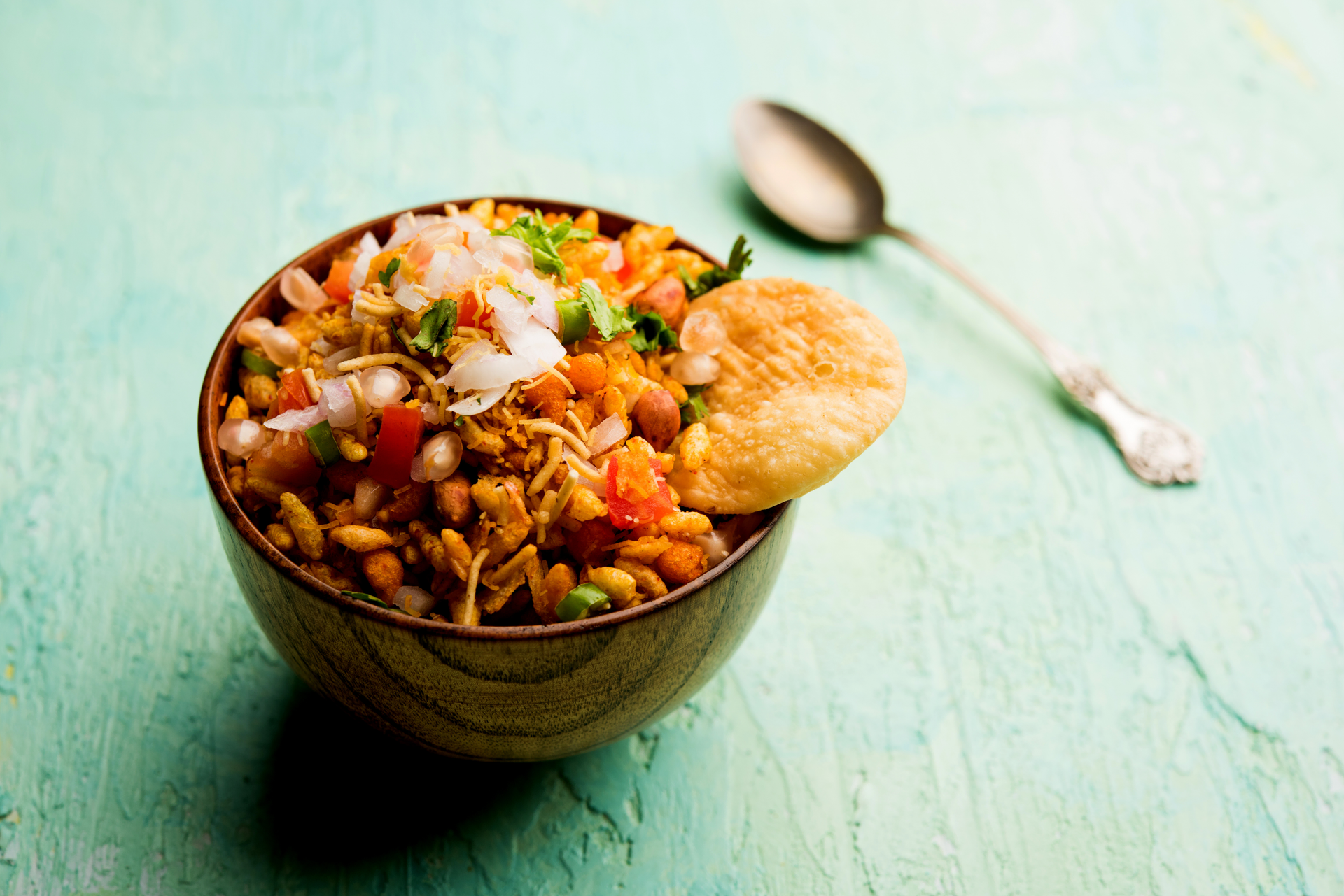 Overhead flat-lay of all ingredients for Tangy Indian Bhel Puri laid out on a kitchen surface.