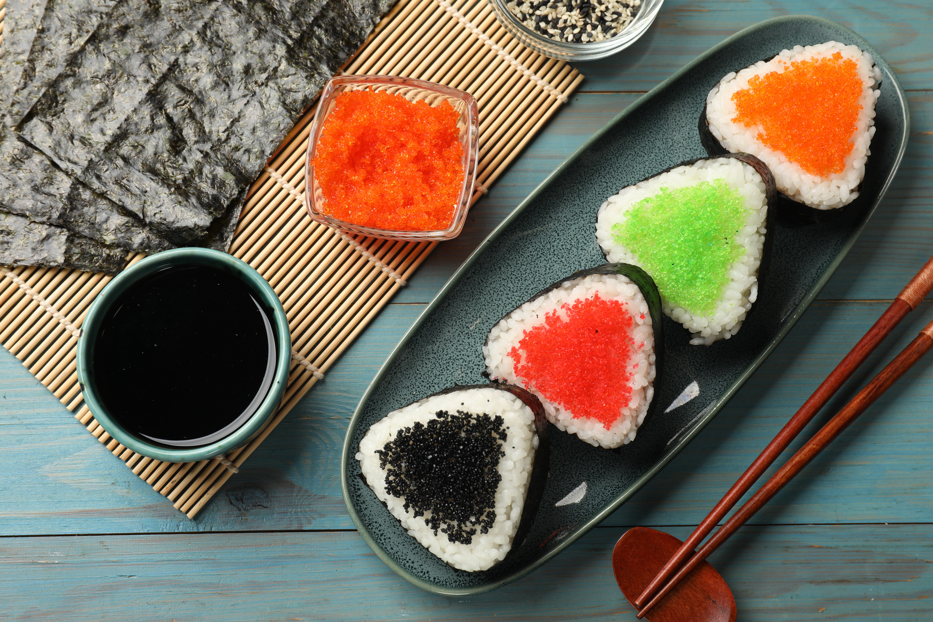 Overhead flat-lay of all ingredients for Tangy Japanese Umeboshi Onigiri with Seaweed Wrap laid out on a kitchen surface.