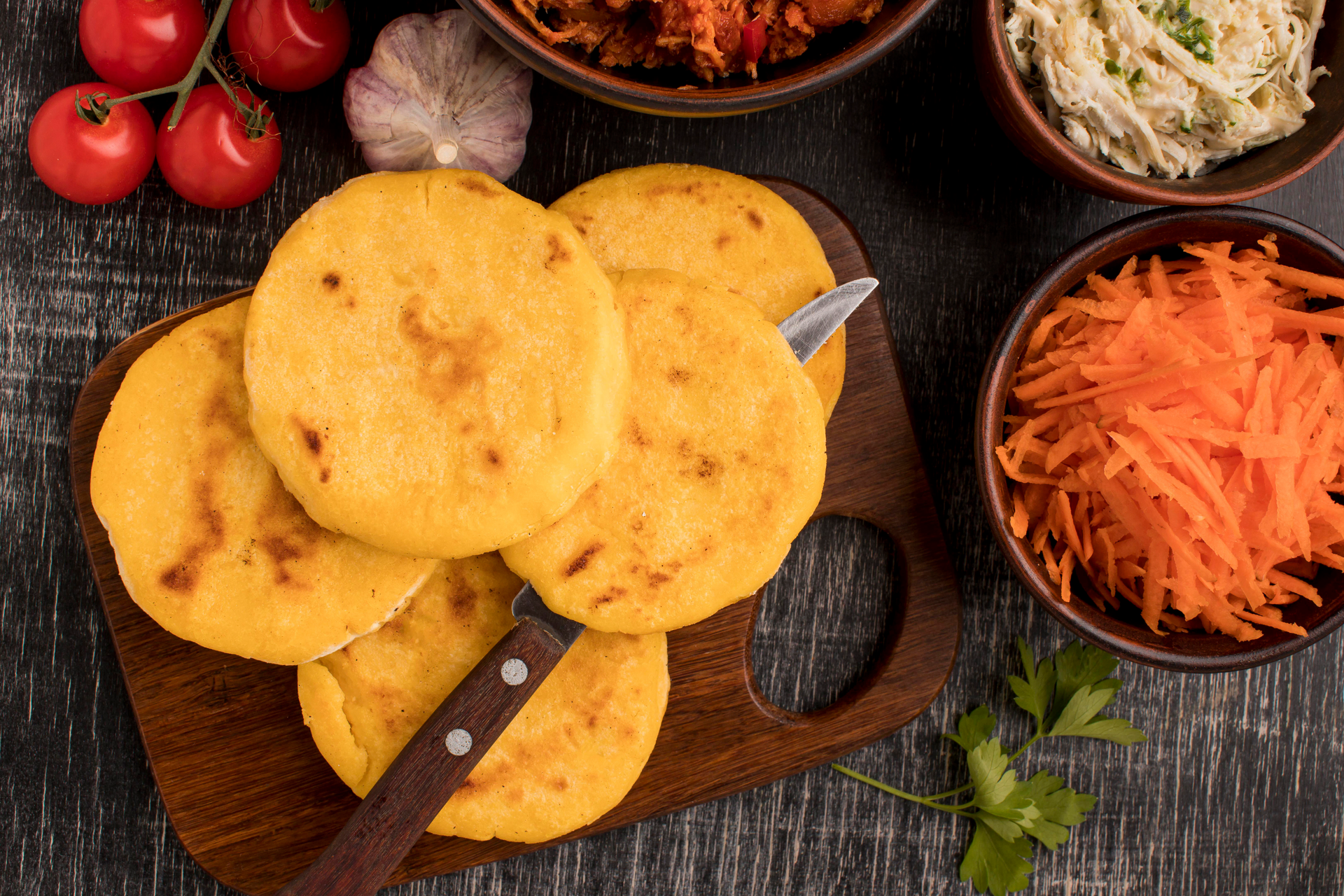Overhead flat-lay of all ingredients for Authentic Salvadoran pupusas with homemade curtido laid out on a kitchen surface.