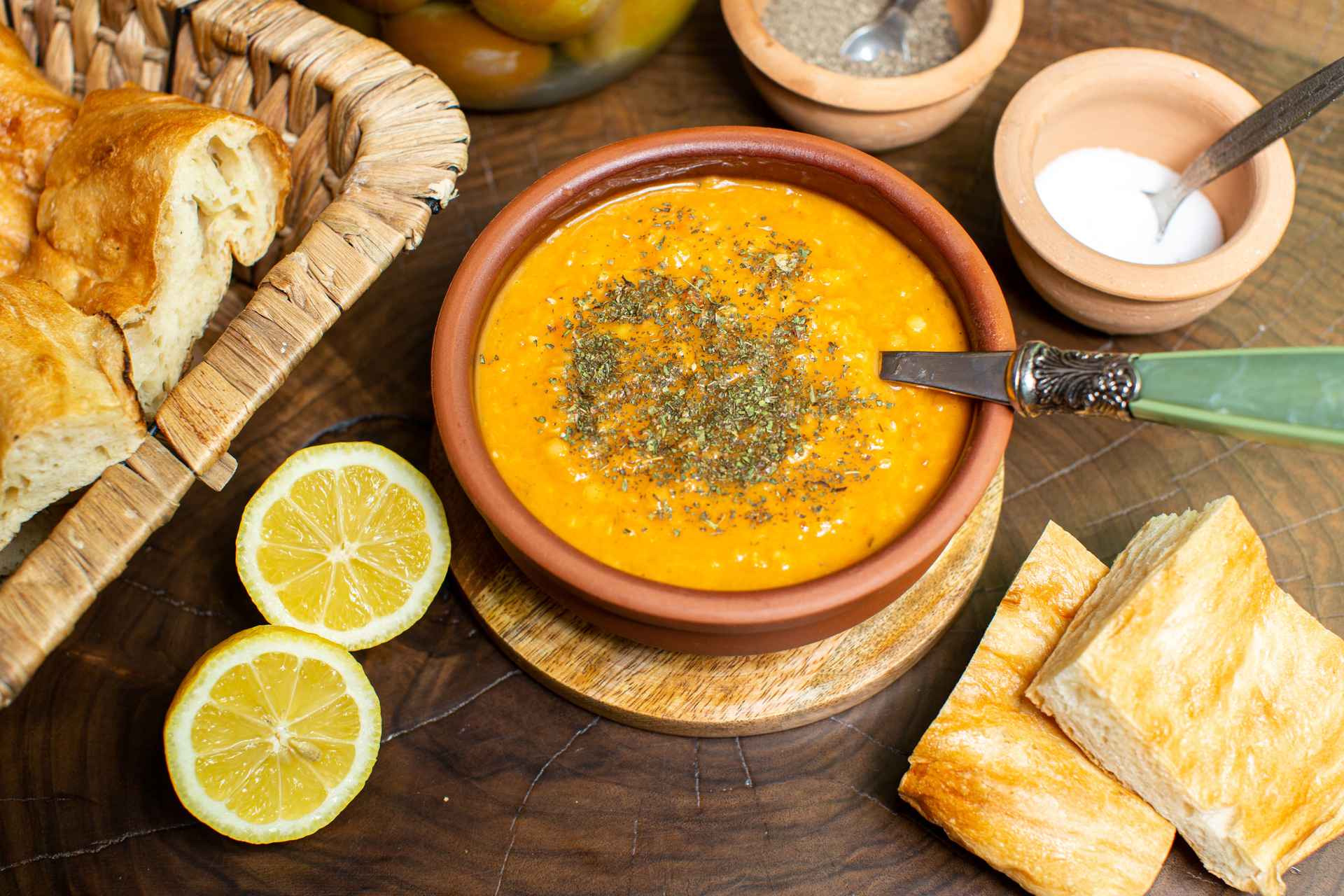 Overhead flat-lay of all ingredients for Tangy Tunisian Harira with Preserved Lemons laid out on a kitchen surface.