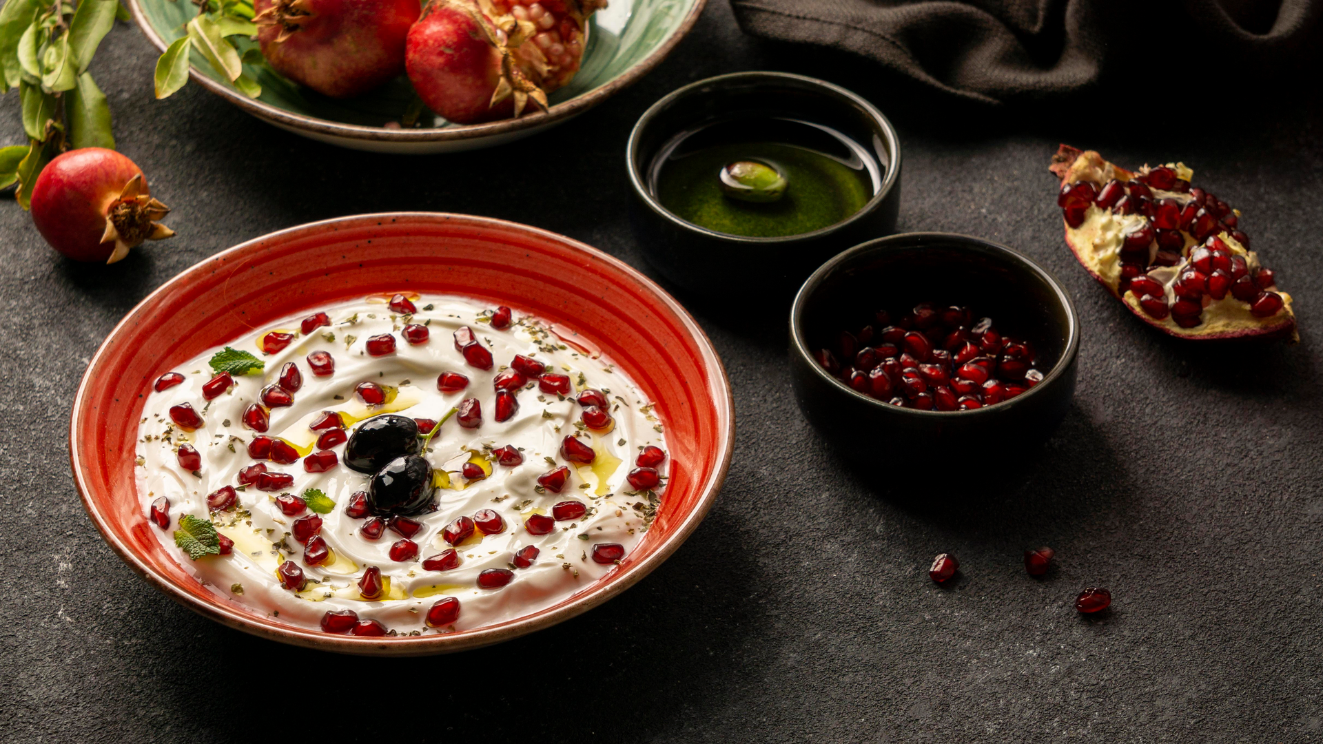 Overhead flat-lay of all ingredients for Tangy Turkish Tarator with Walnut and Pomegranate Molasses laid out on a kitchen surface.