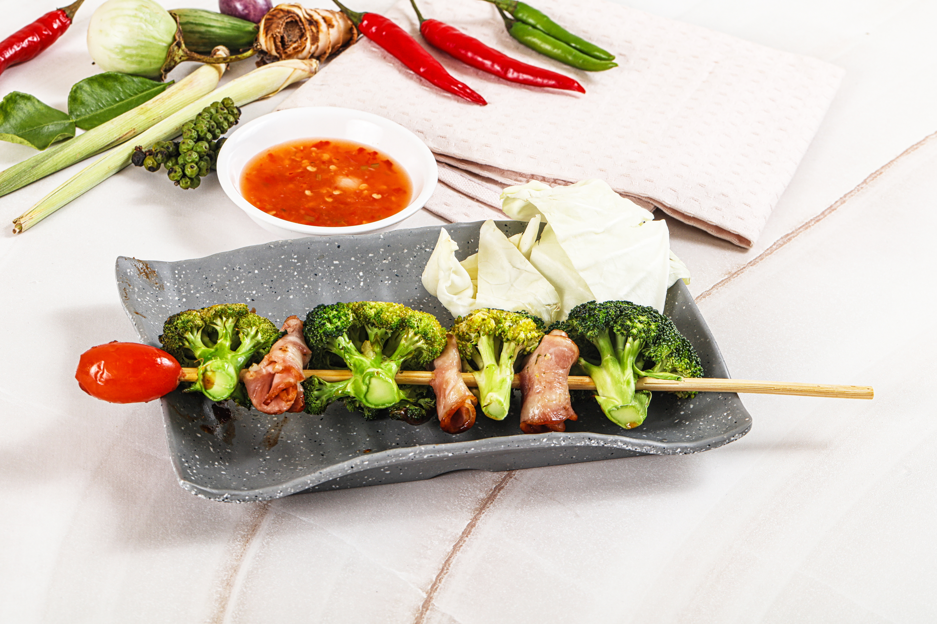 Overhead flat-lay of all ingredients for Tangy Vietnamese Lemongrass Pork Skewers with Pickled Daikon laid out on a kitchen surface.