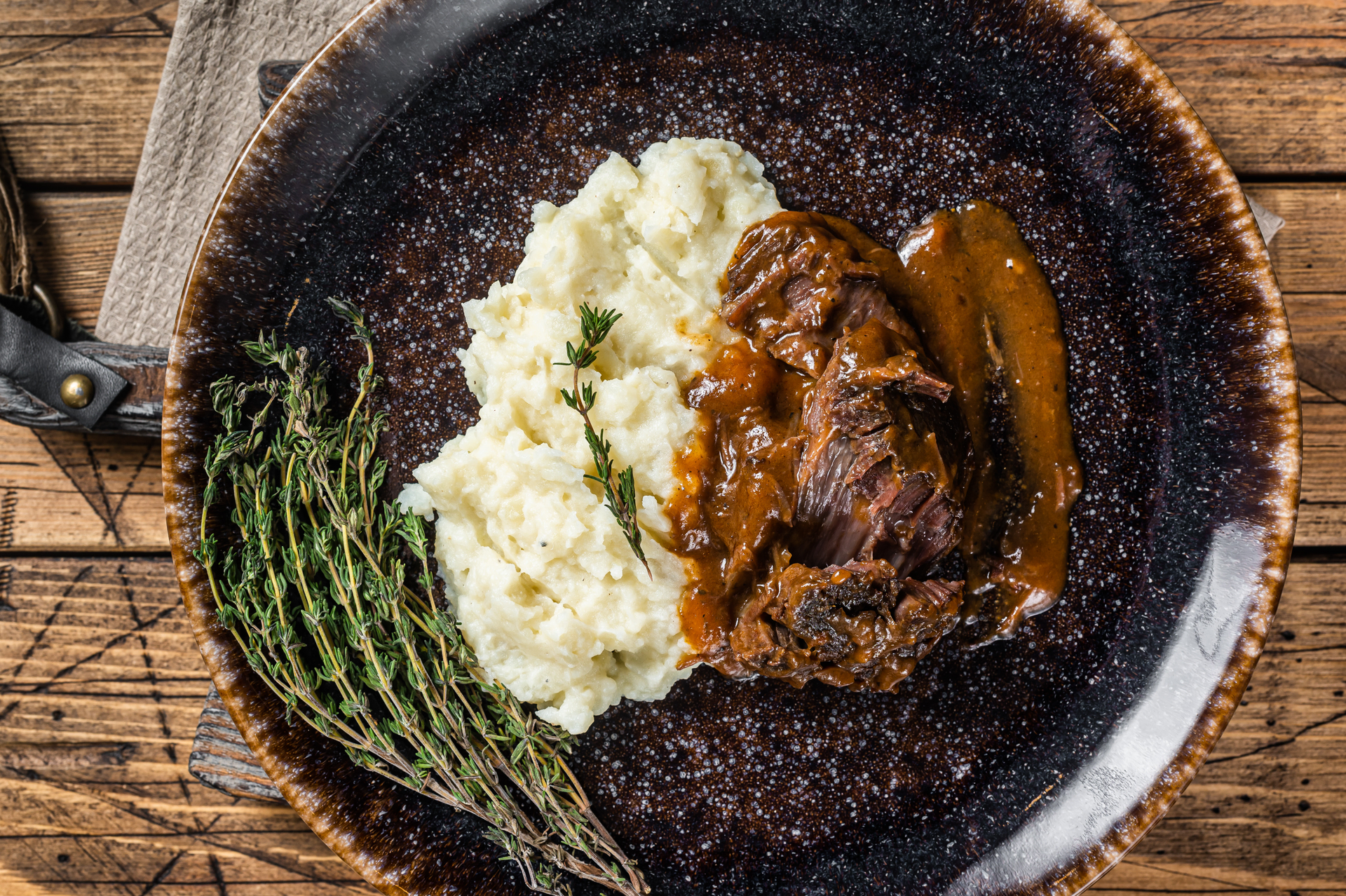 Overhead flat-lay of all ingredients for Tender Guinness Beef Stew with Caramelized Shallots on Mashed Potatoes laid out on a kitchen surface.