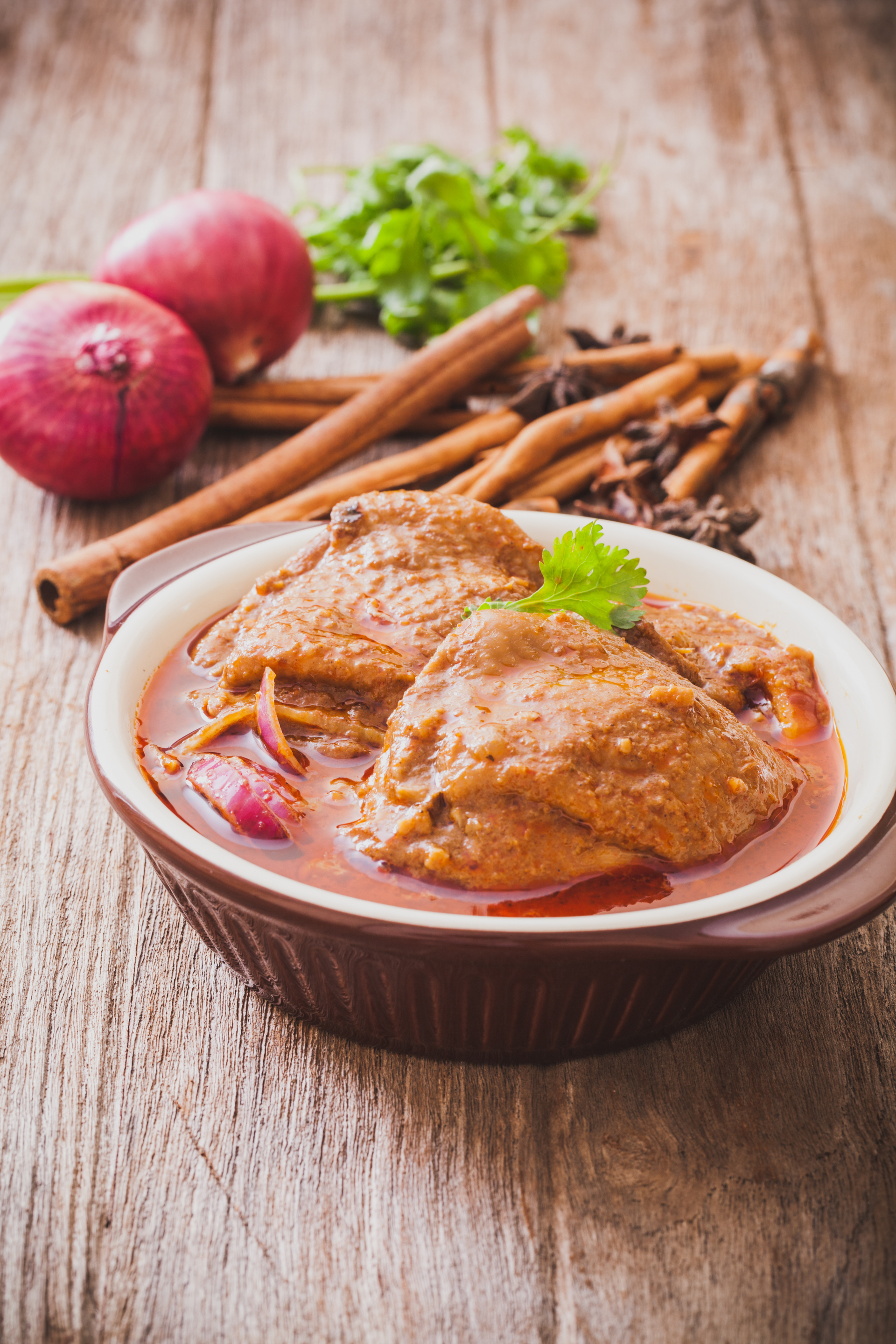 Overhead flat-lay of all ingredients for Tender Pakistani Nihari with Bone Marrow laid out on a kitchen surface.