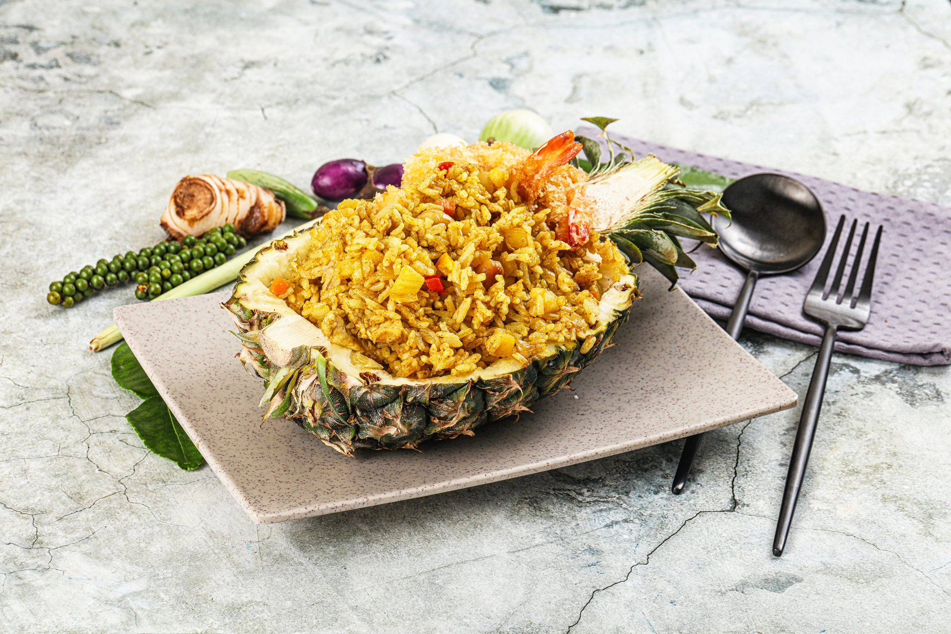 Overhead flat-lay of all ingredients for Thai Pineapple Fried Rice with Cashews and Curry Powder laid out on a kitchen surface.