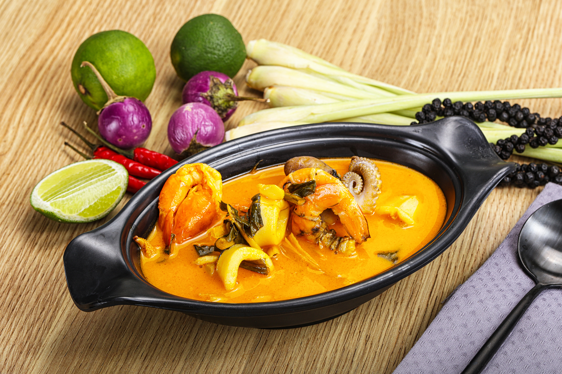 Overhead flat-lay of all ingredients for Thai Red Curry Mussels with Thai Basil and Lemongrass laid out on a kitchen surface.