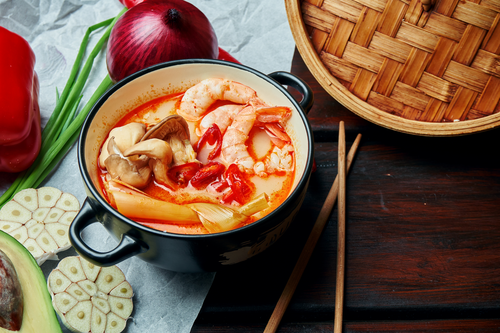 Overhead flat-lay of all ingredients for Thai Tom Yum Goong laid out on a kitchen surface.