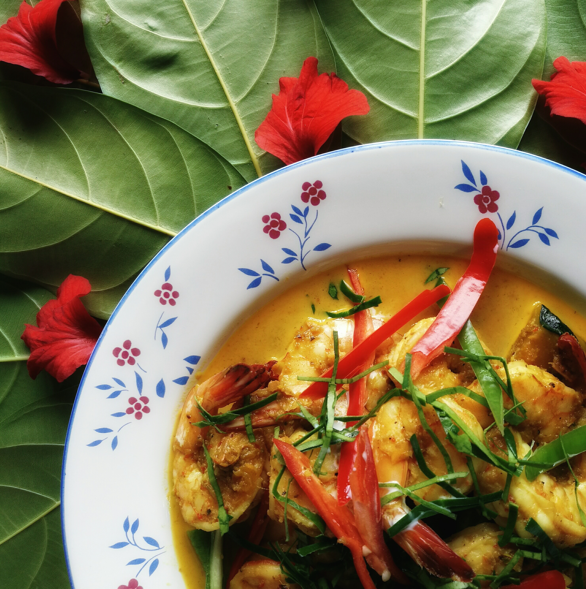 Overhead flat-lay of all ingredients for Tropical Caribbean Pineapple Curry with Rum-Infused Chicken laid out on a kitchen surface.