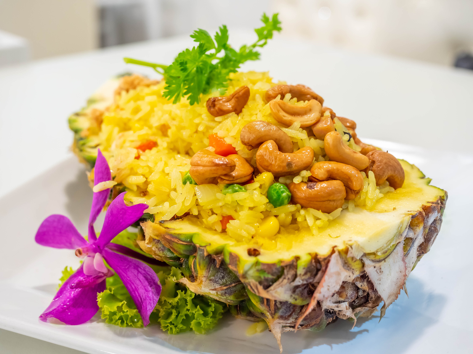 Overhead flat-lay of all ingredients for Tropical Pineapple and Passion Fruit Salsa with Grilled Snapper laid out on a kitchen surface.