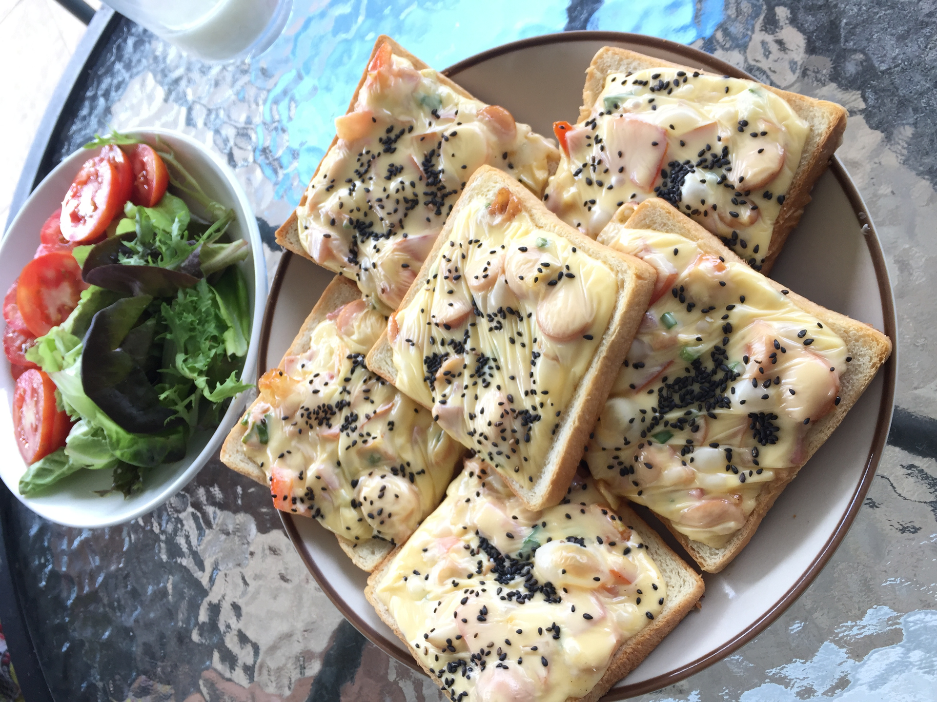 Overhead flat-lay of all ingredients for Turkish Feta-Stuffed Flatbreads with Nigella Seeds laid out on a kitchen surface.