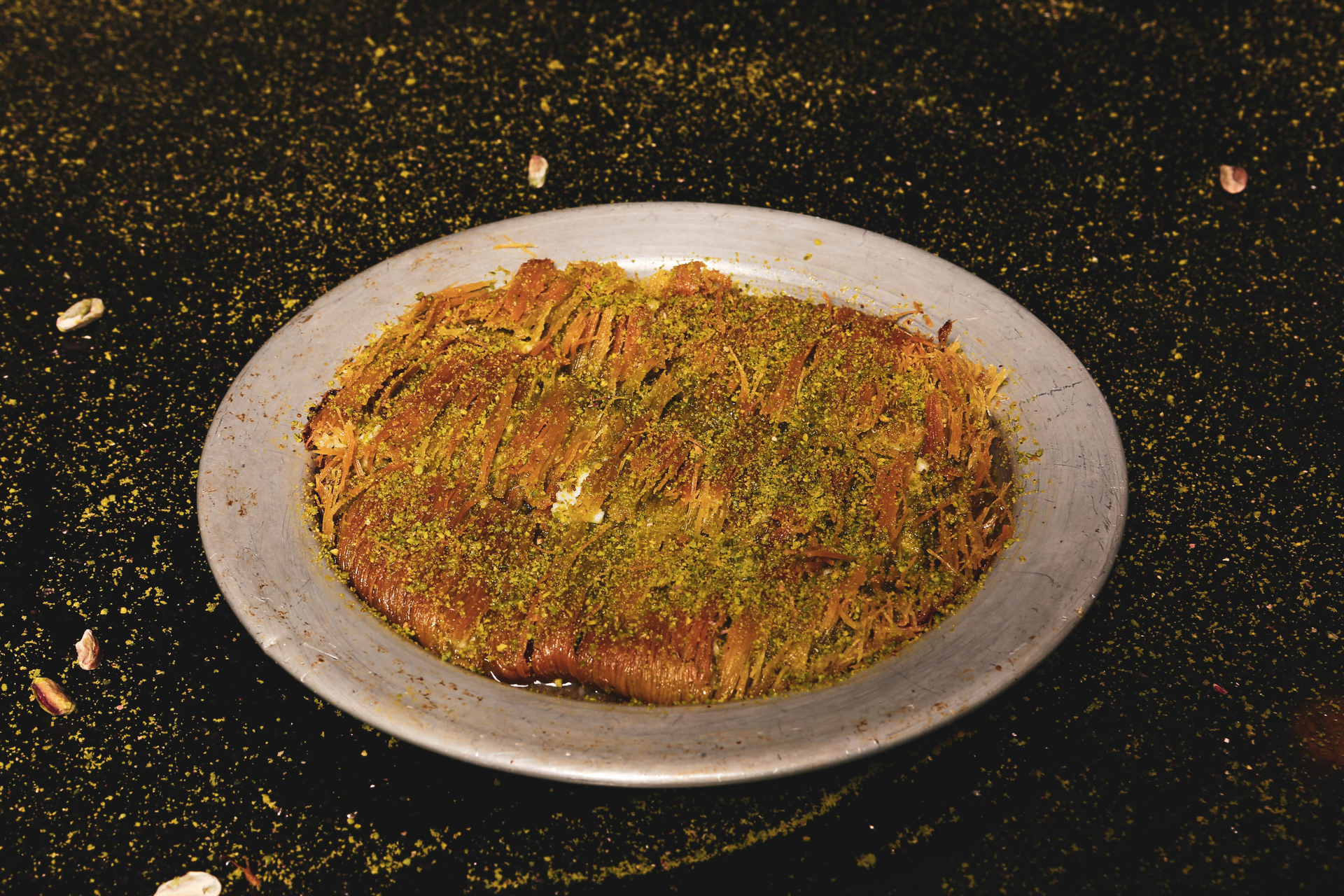 Overhead flat-lay of all ingredients for Turkish Kunefe with Pistachio and Rose Water Syrup laid out on a kitchen surface.