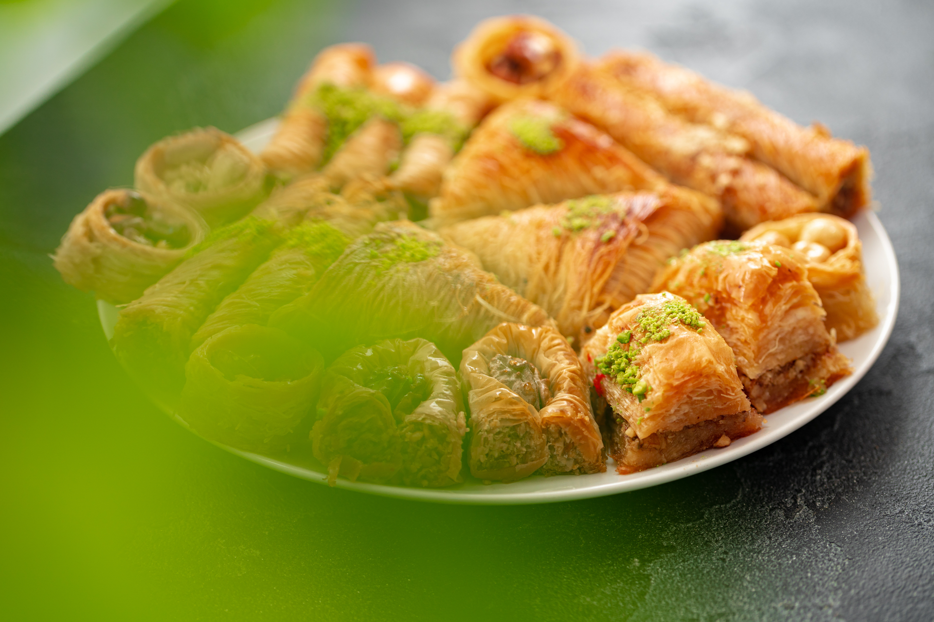 Overhead flat-lay of all ingredients for Turkish Pistachio Baklava with Lemon-Infused Syrup laid out on a kitchen surface.