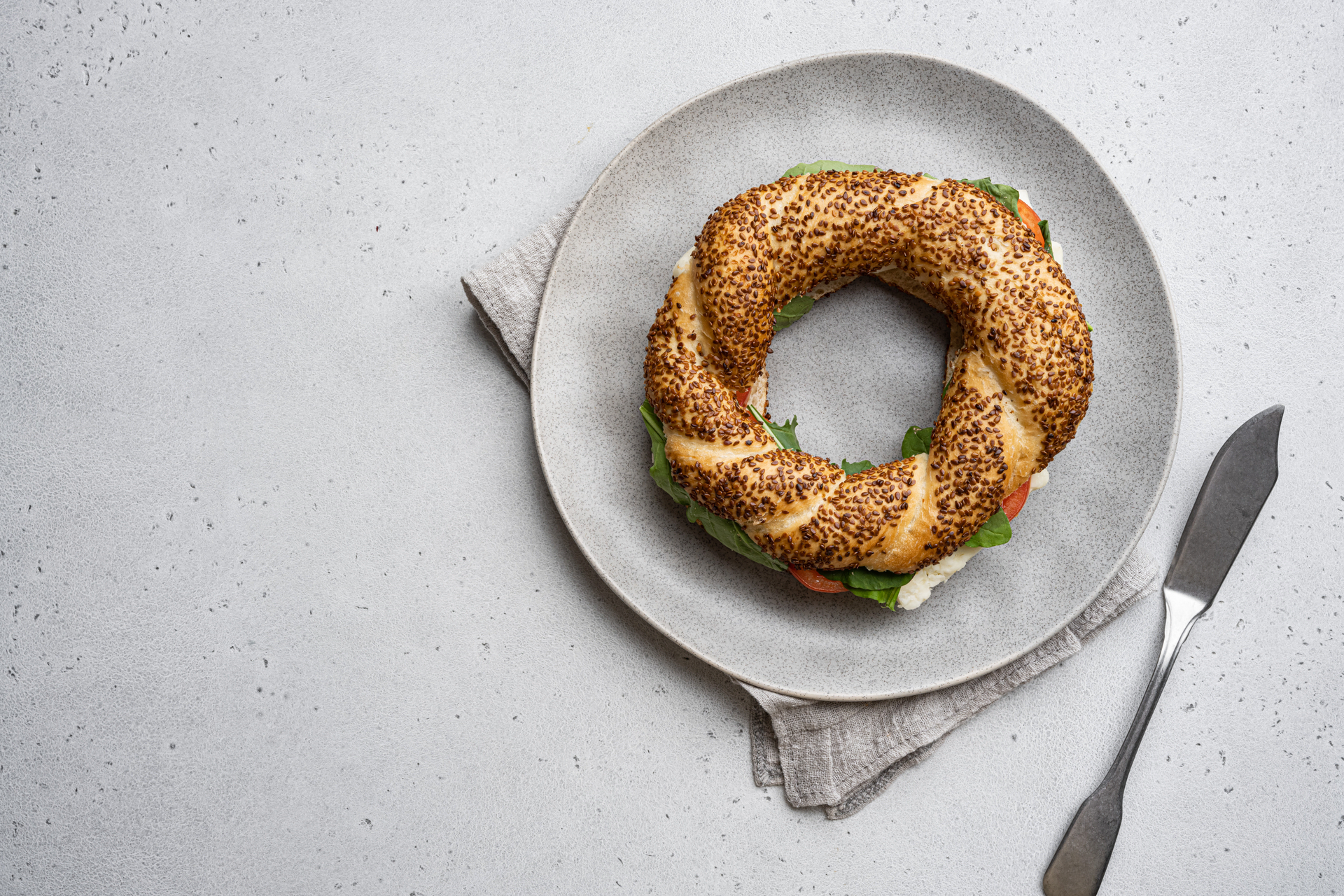 Overhead flat-lay of all ingredients for Turkish Simit with Sesame Seeds and Molasses laid out on a kitchen surface.