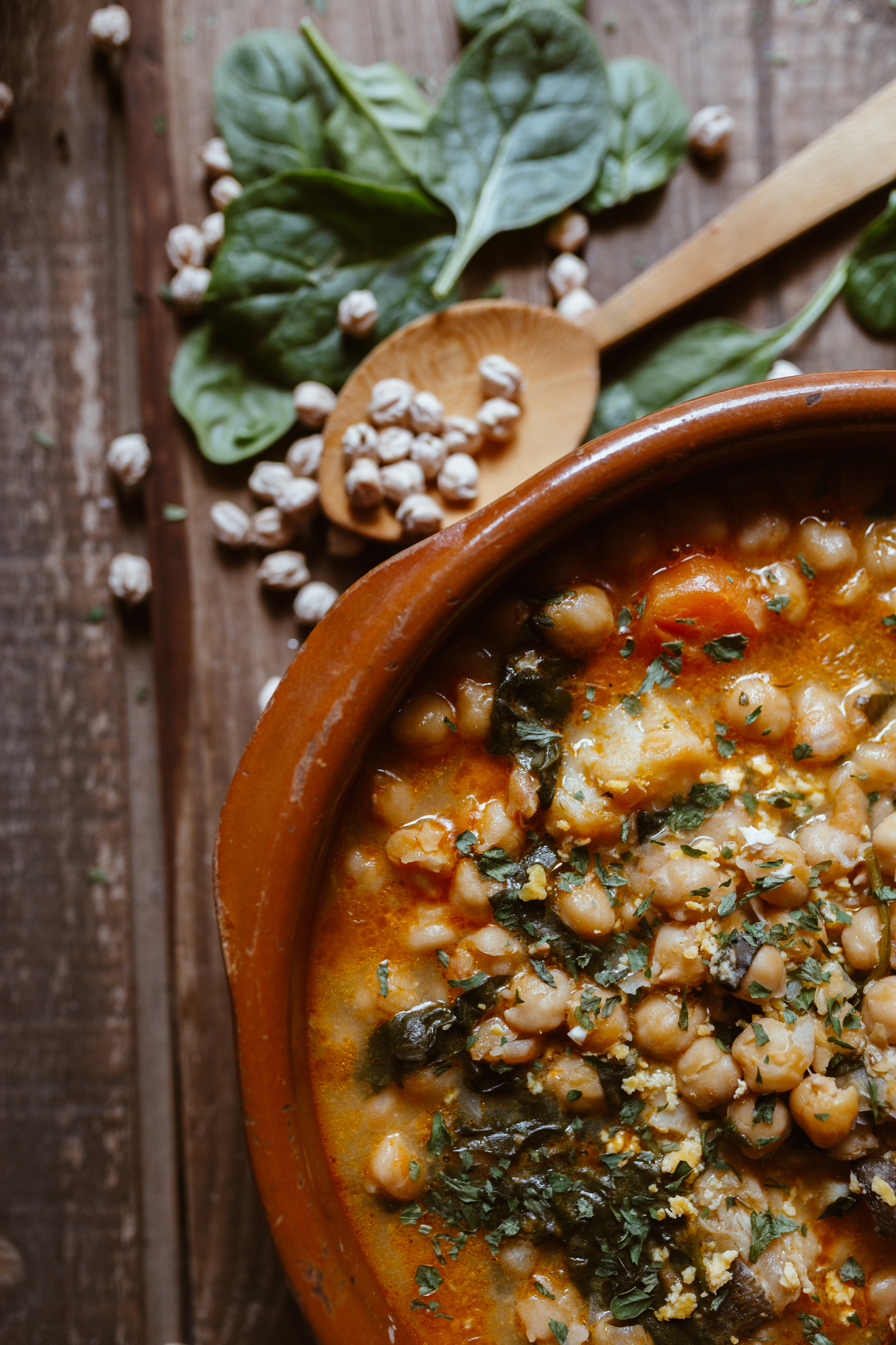 Overhead flat-lay of all ingredients for Tuscan Ribollita with Cannellini Beans and Kale laid out on a kitchen surface.